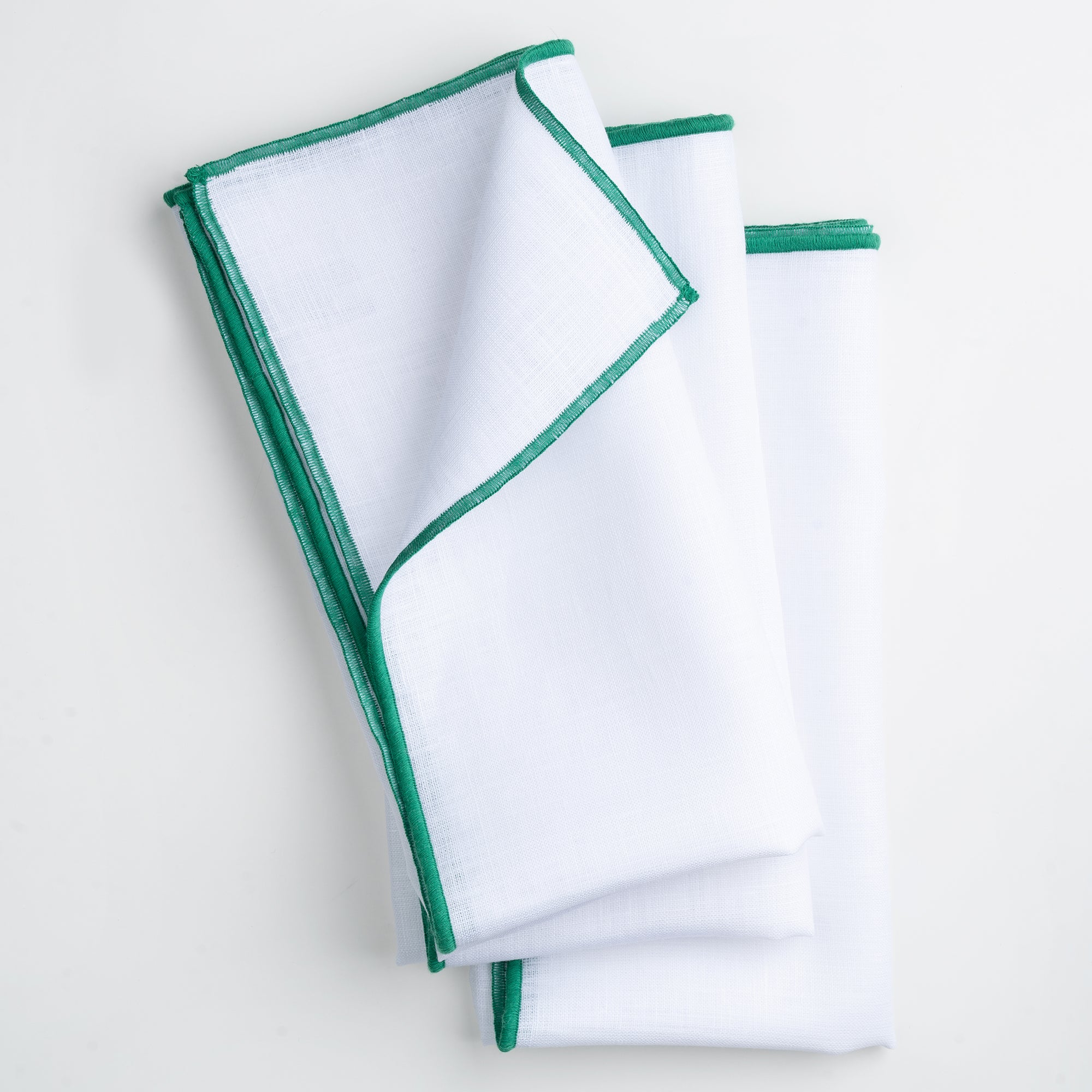 Close-up of the marrow edge on white and green pure linen dinner napkins