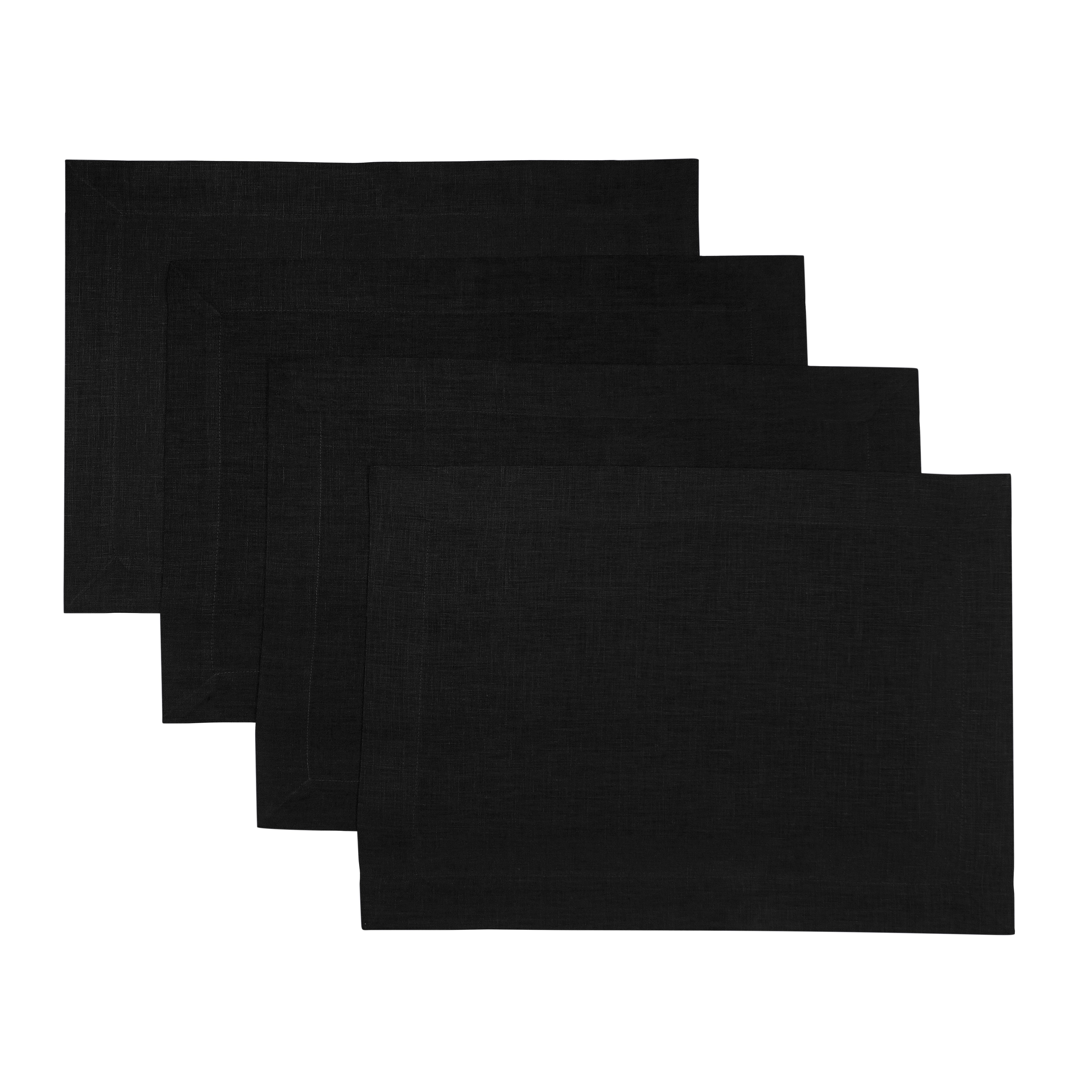 Black linen placemats styled on a dining table
