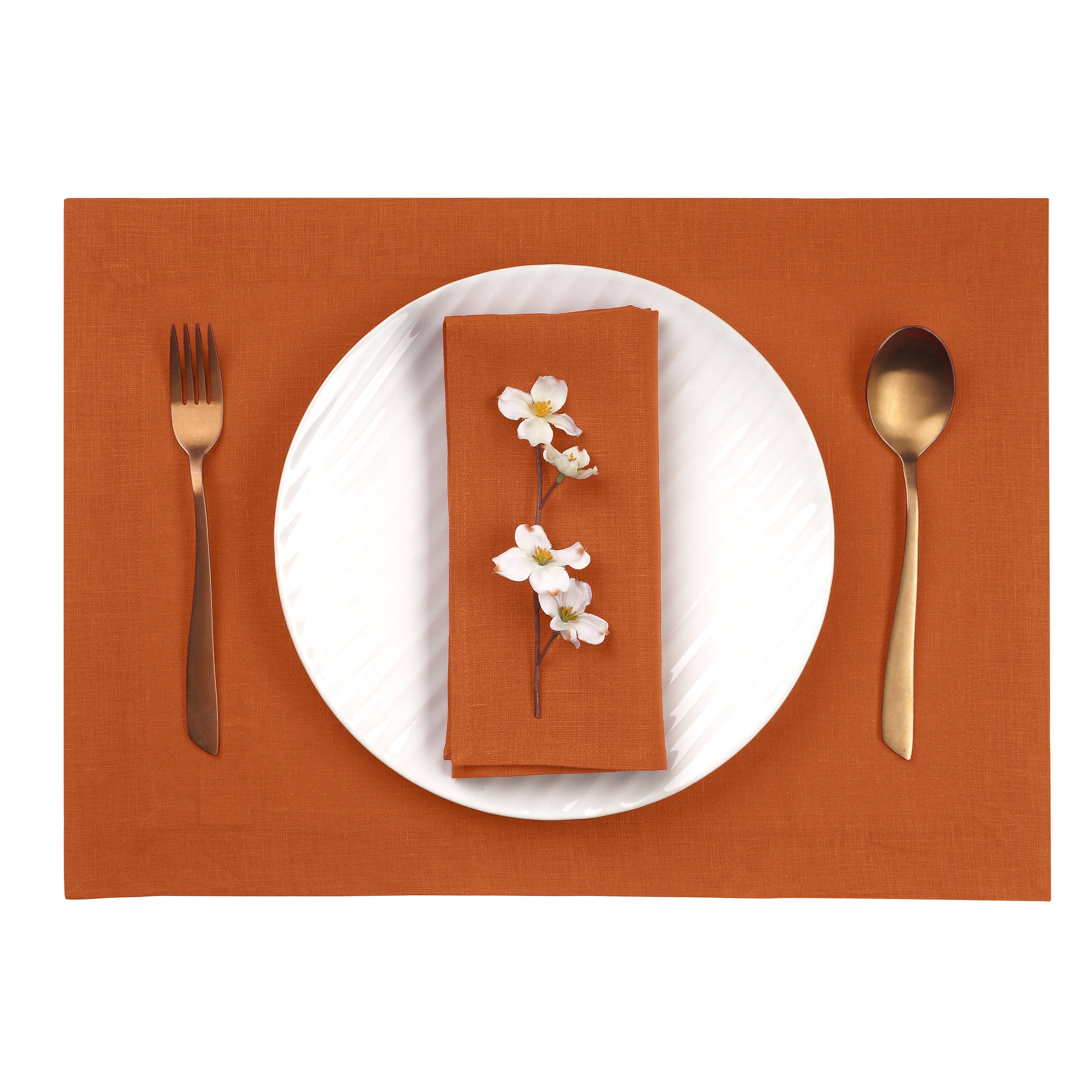 Close-up of the hemmed edge on rust linen placemats