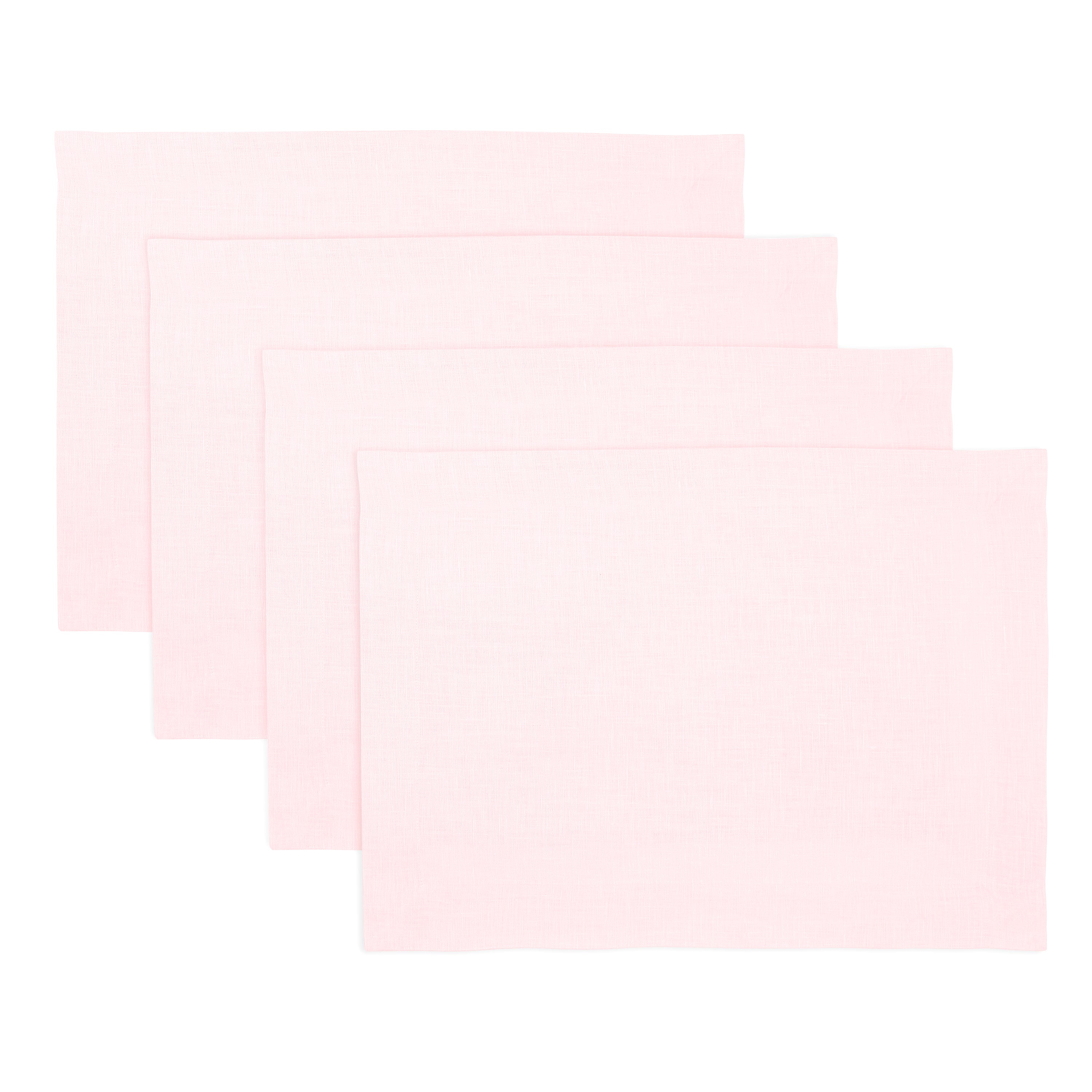 Pastel pink linen placemats styled on a dining table