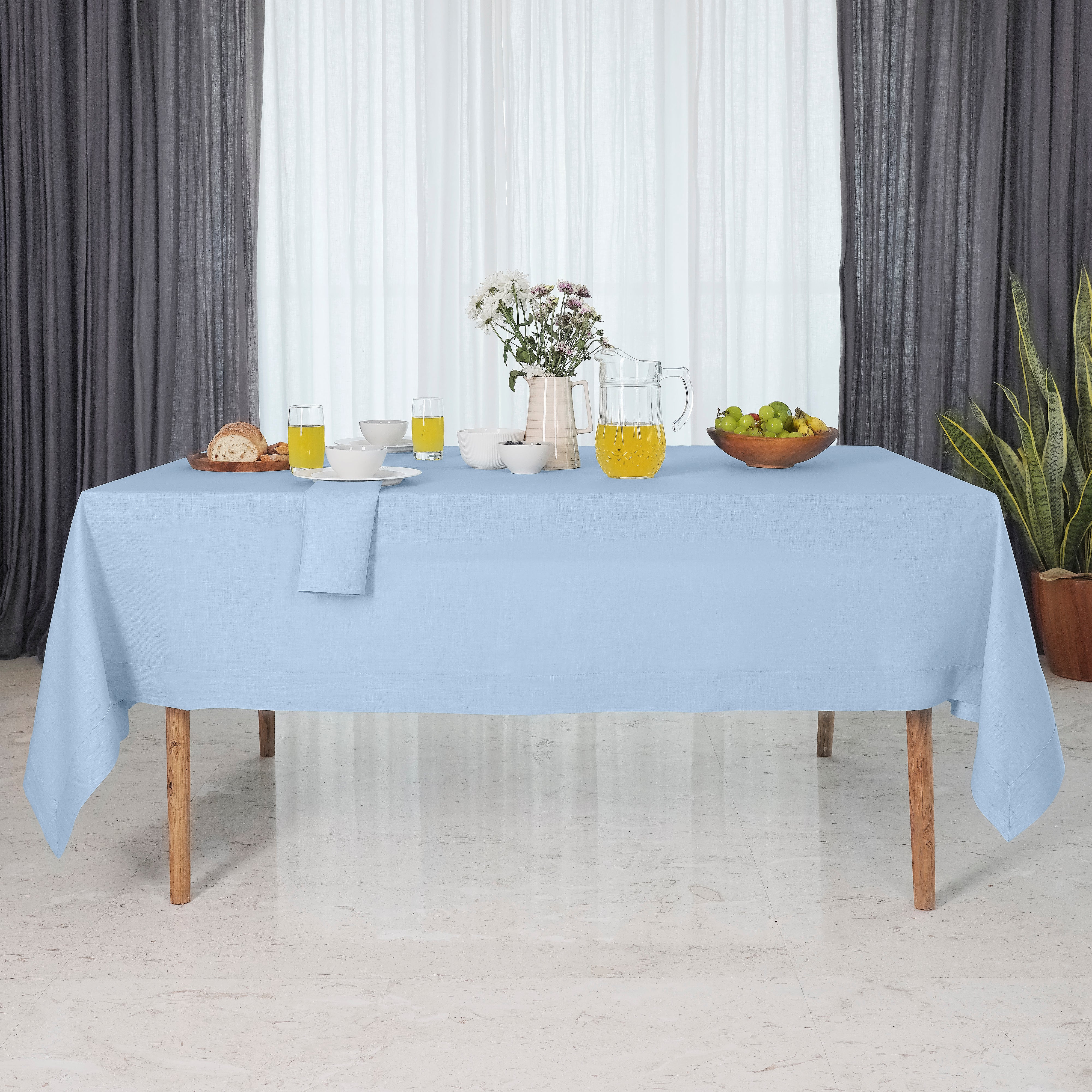 Close-up of the mitered corners on a powder blue pure linen tablecloth