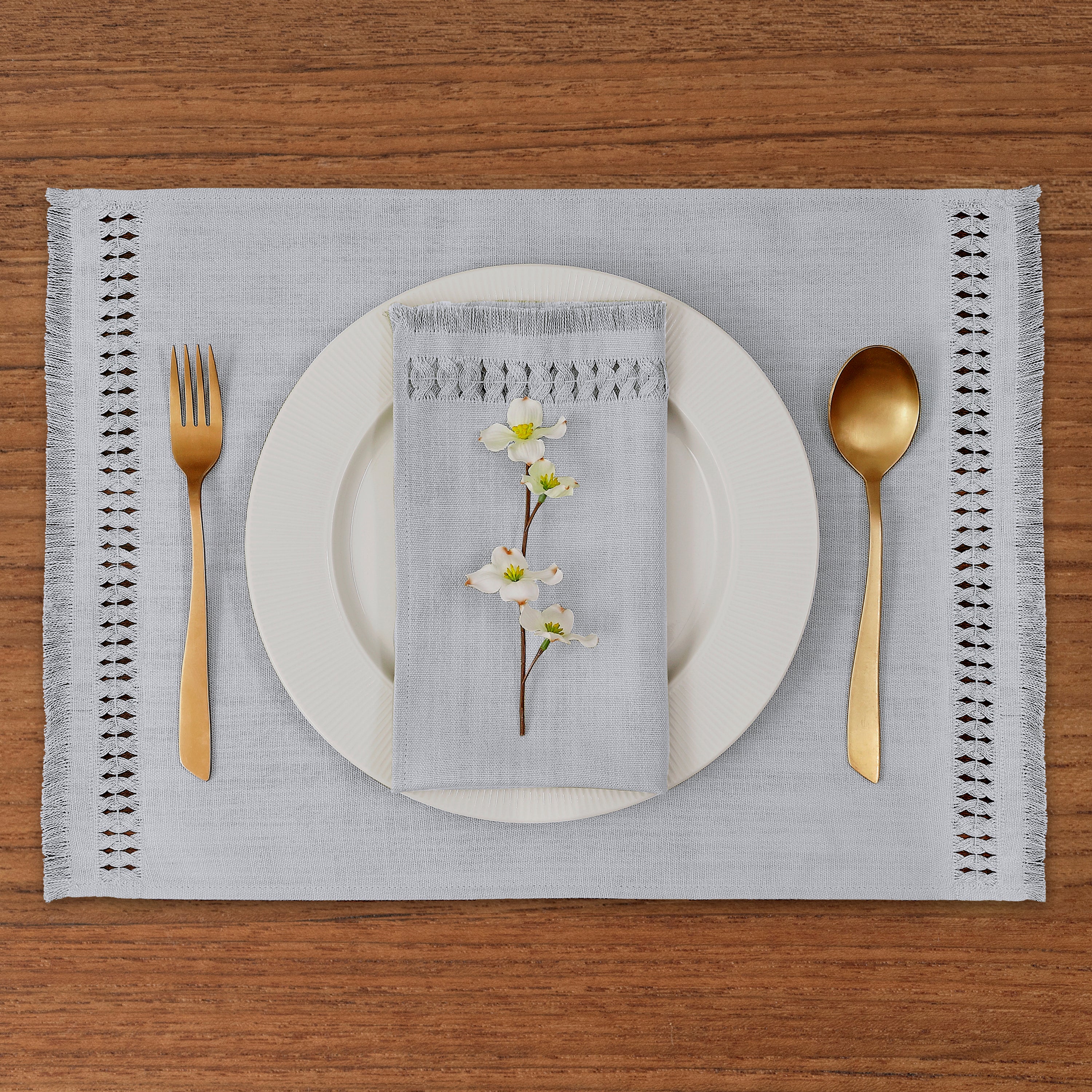Close-up of the hand-hemstitch edge on light grey faux linen placemats