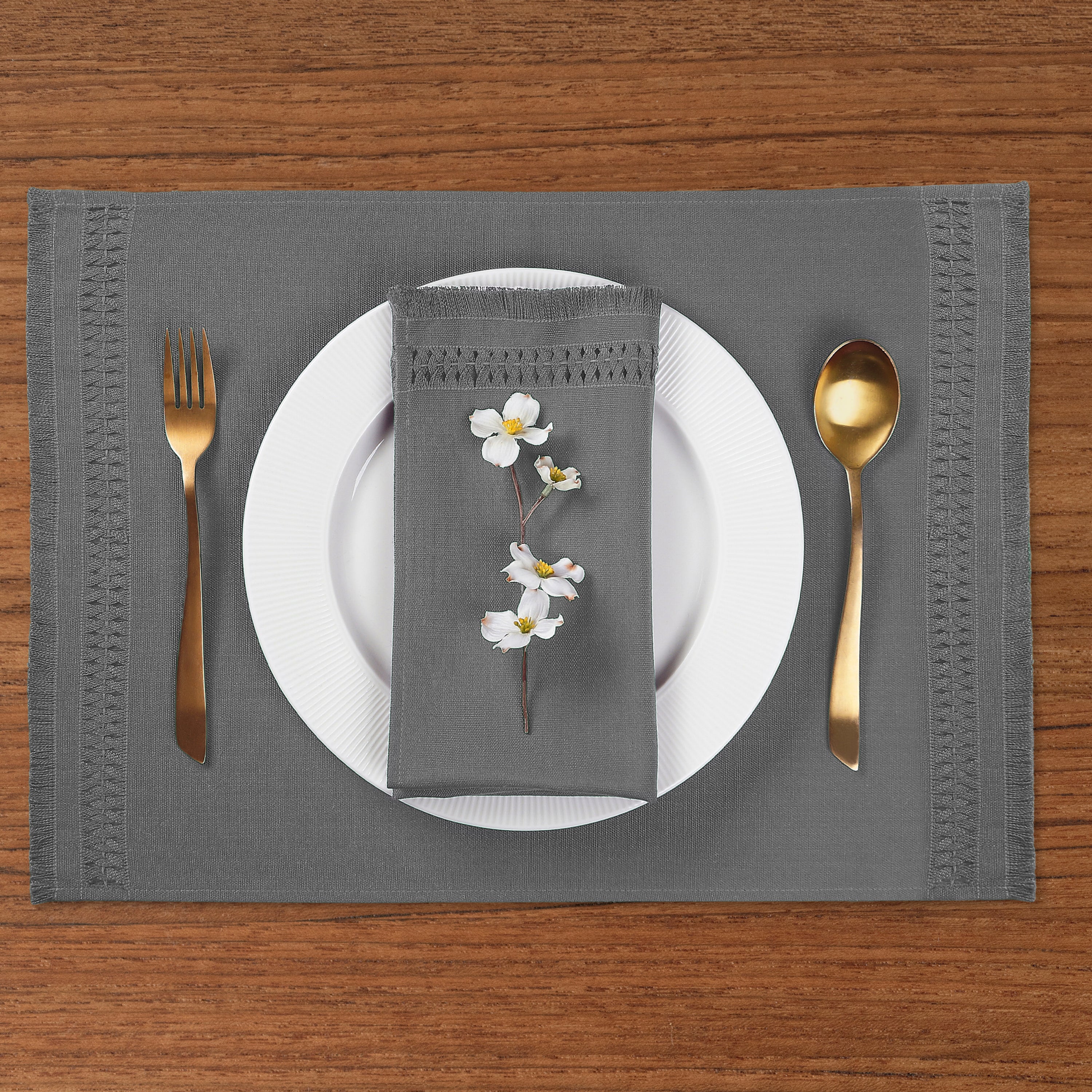 Close-up of the hand-hemstitch edge on charcoal grey faux linen placemats