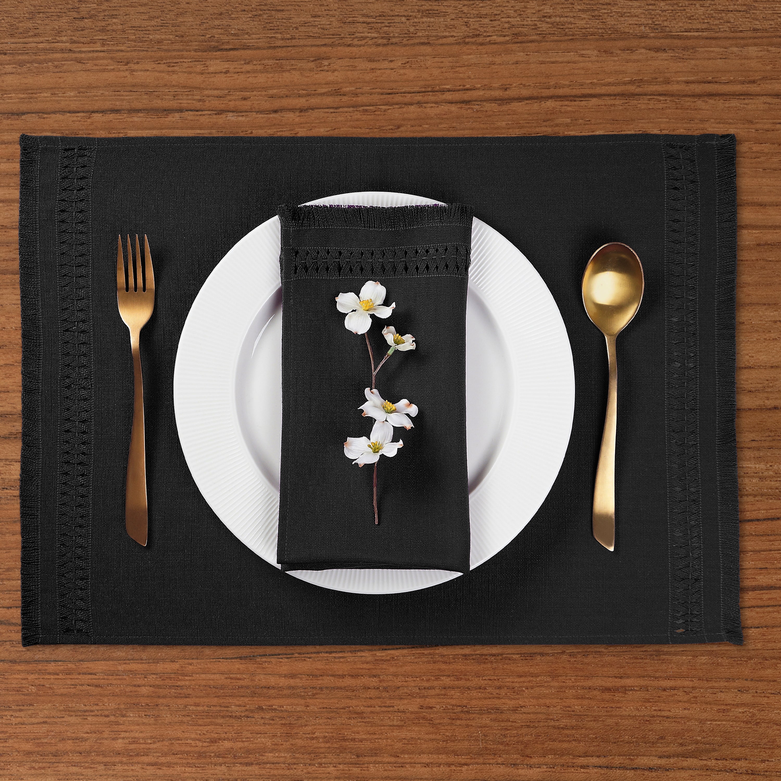 Close-up of the hand-hemstitch edge on black faux linen placemats