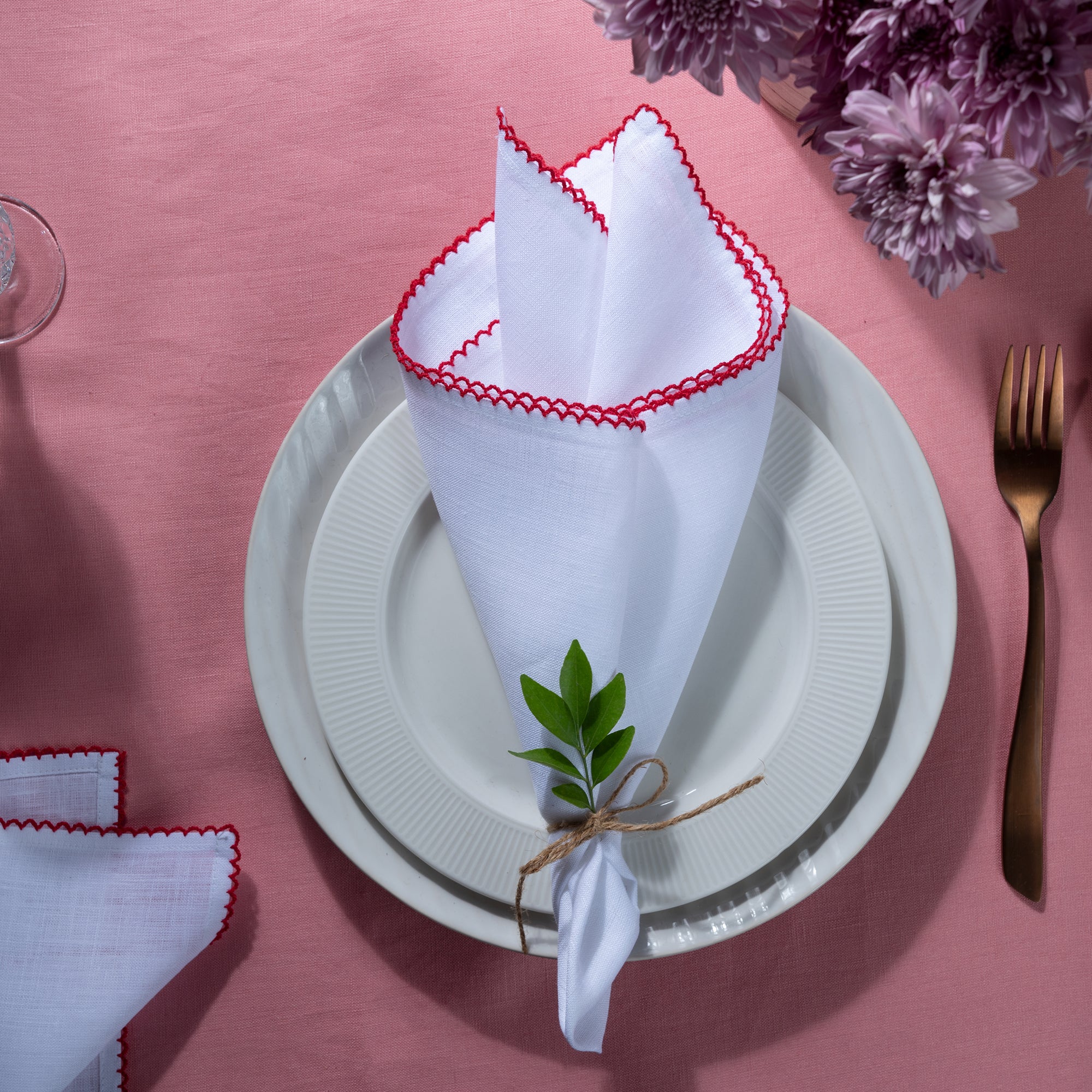 Close-up of the whipstitch edge on white and red pure linen dinner napkins