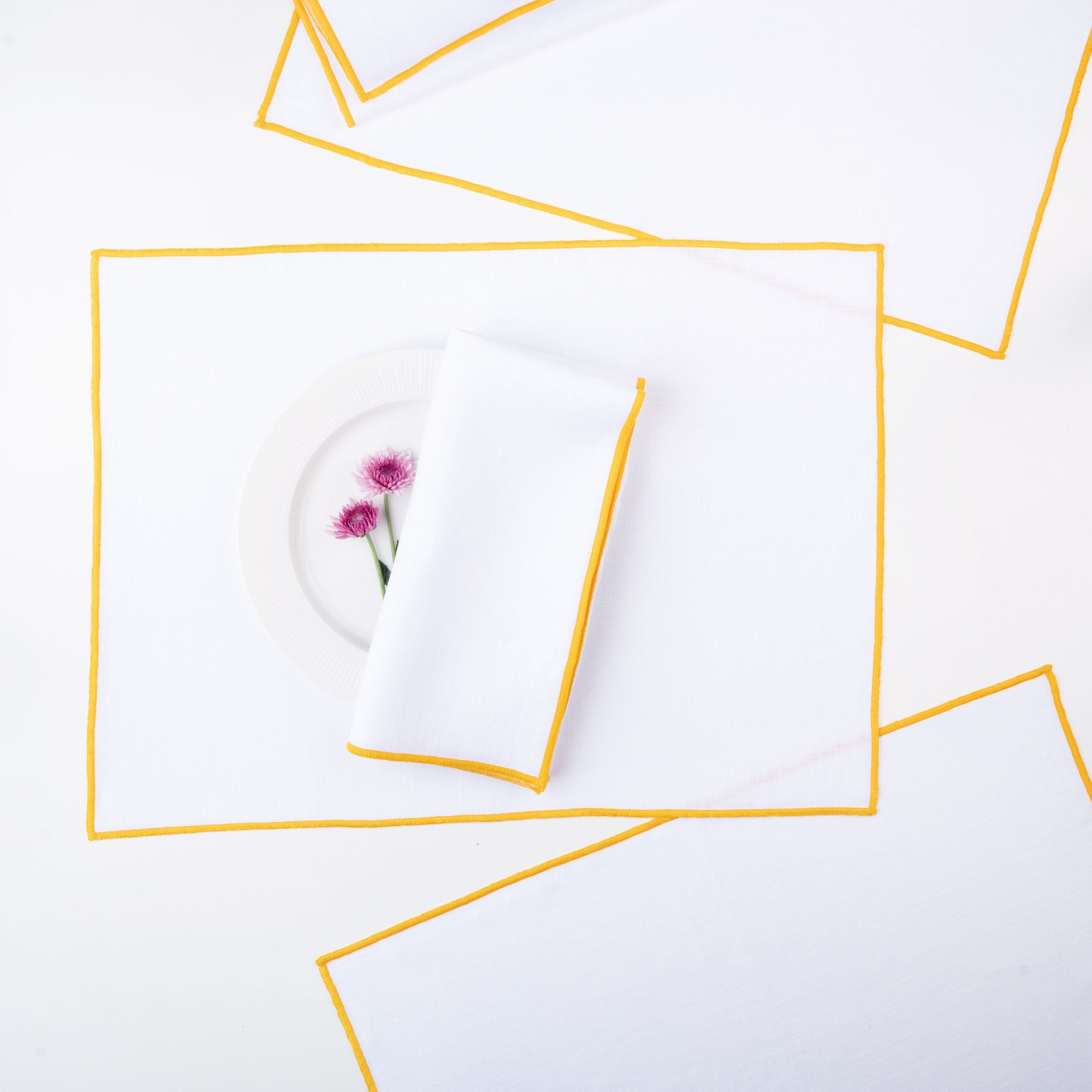 White and yellow pure linen placemats with matching D'Moksha table linens