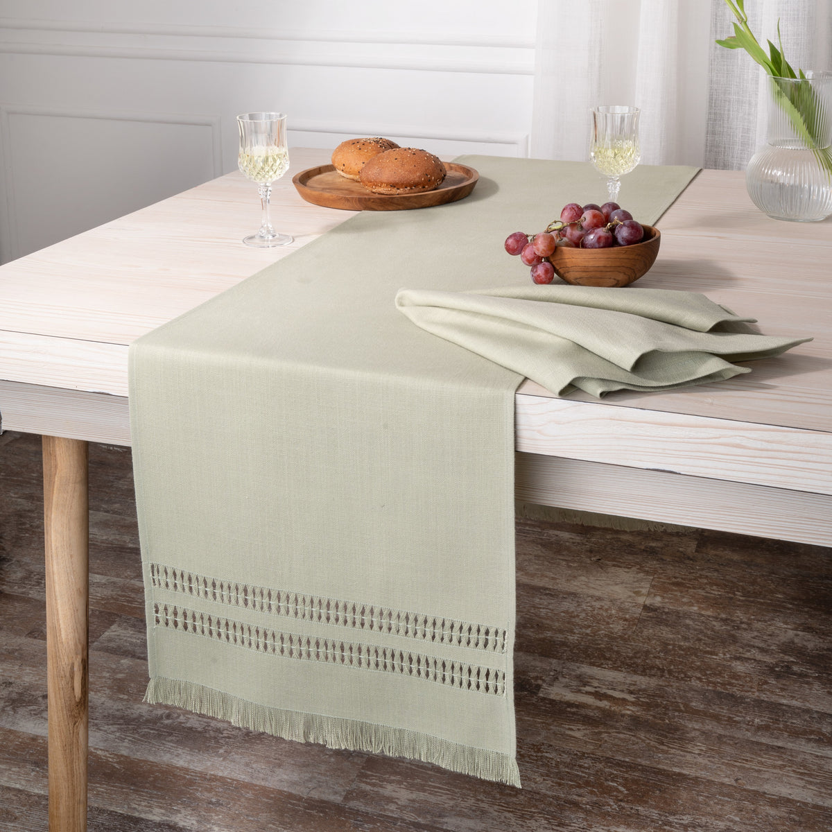 Close-up of the hand-hemstitch edge on a sage green faux linen table runner