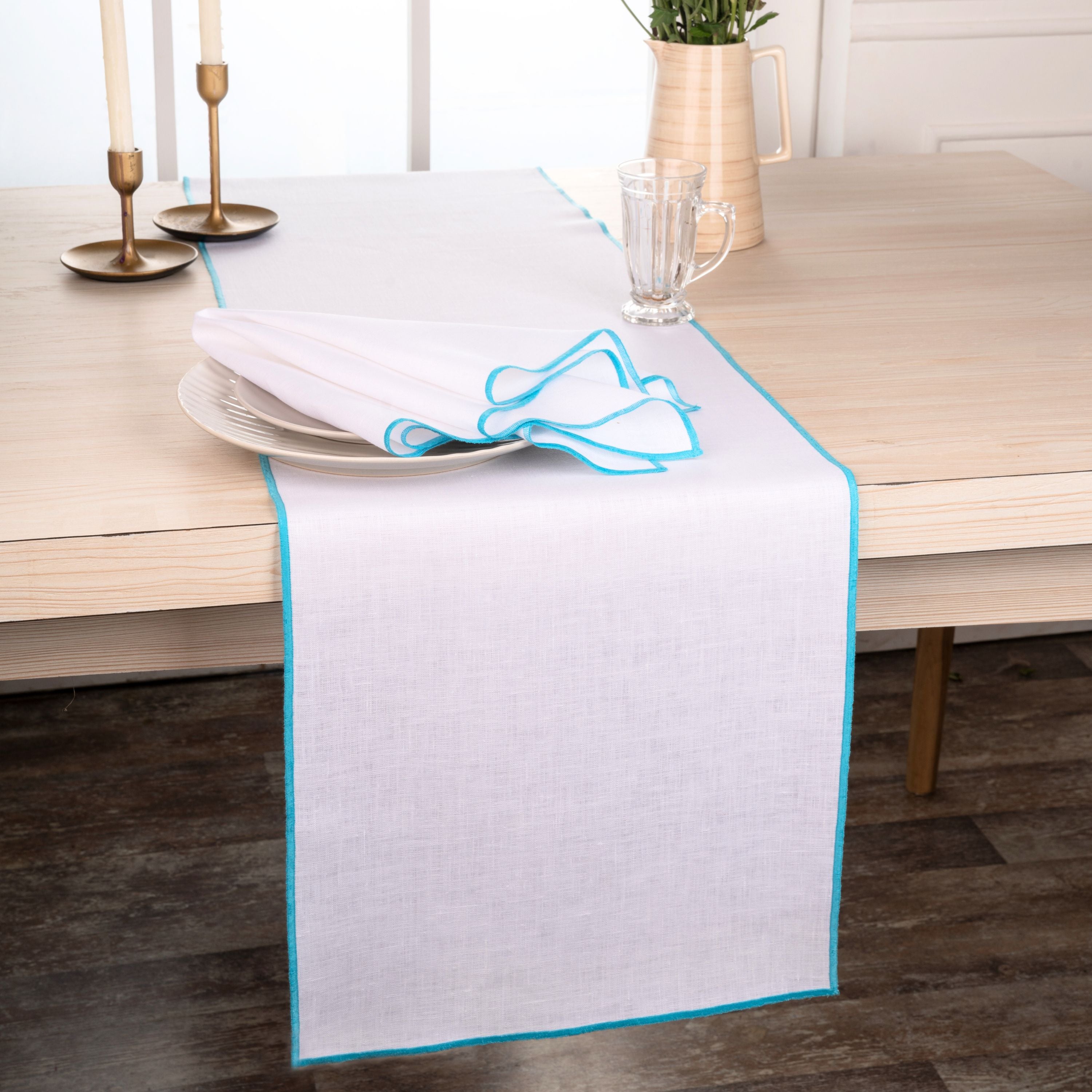Close-up of the marrow edge on a white and blue pure linen table runner