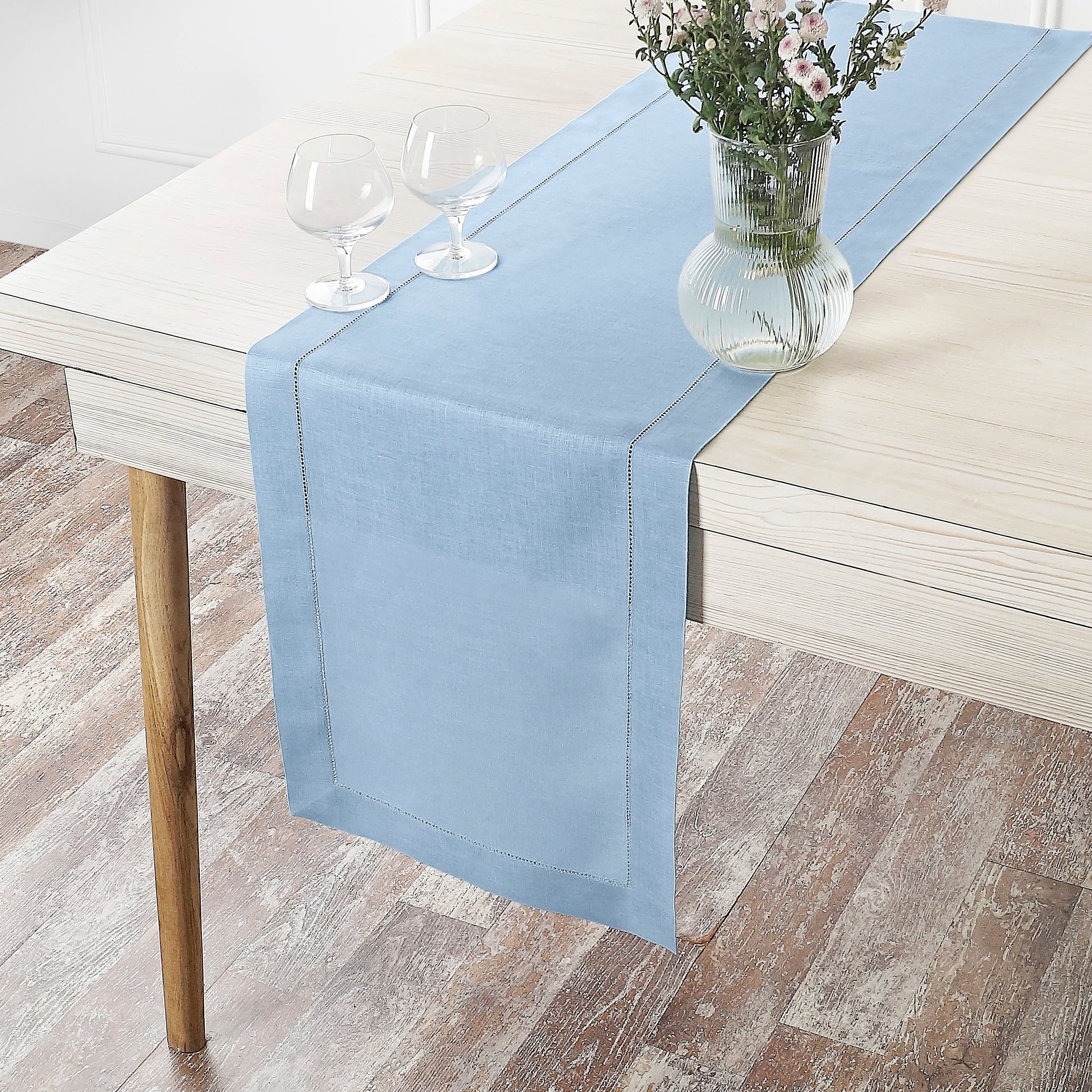 Close-up of the hemstitch edge on a powder blue pure linen table runner