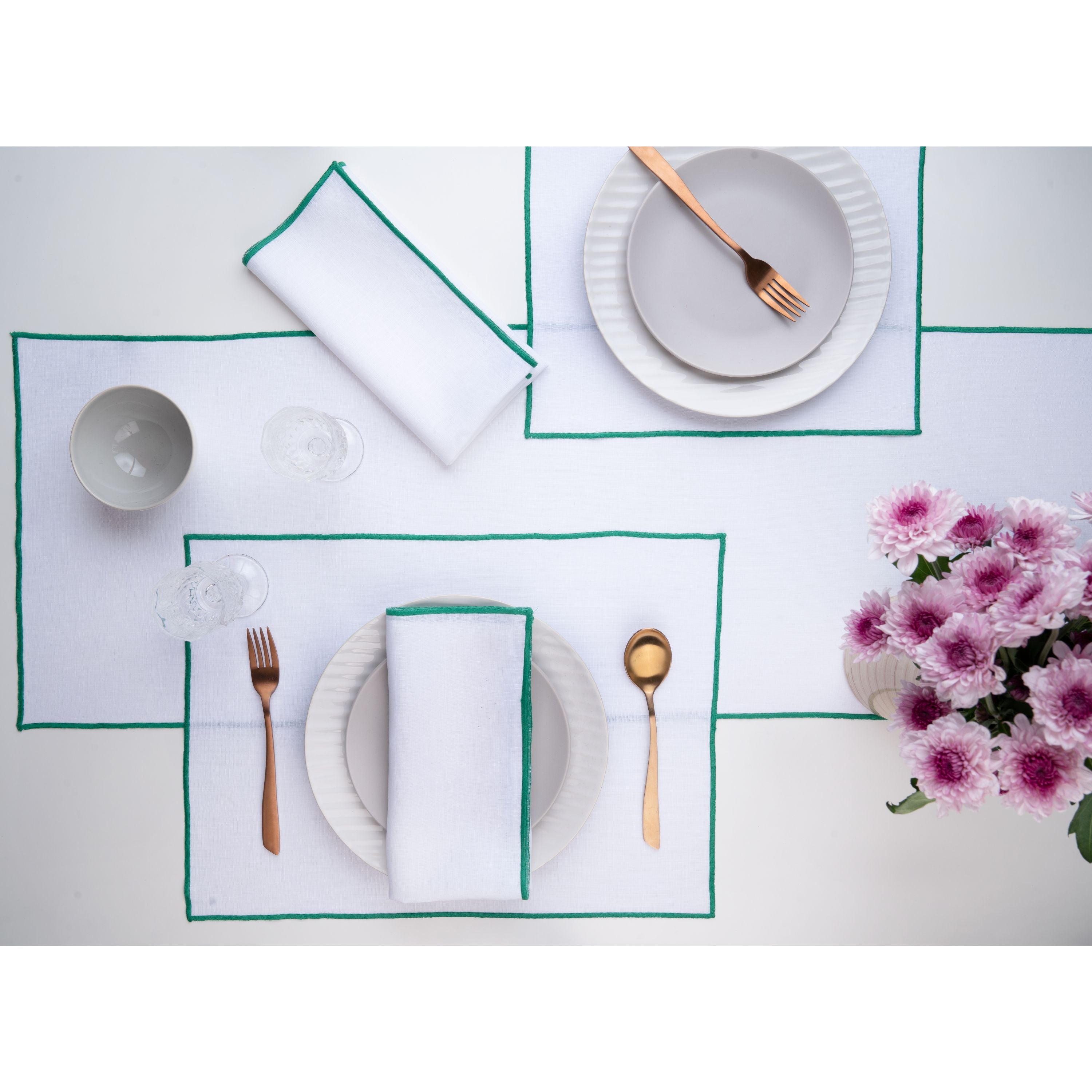 White and green pure linen placemats folded to show fabric texture