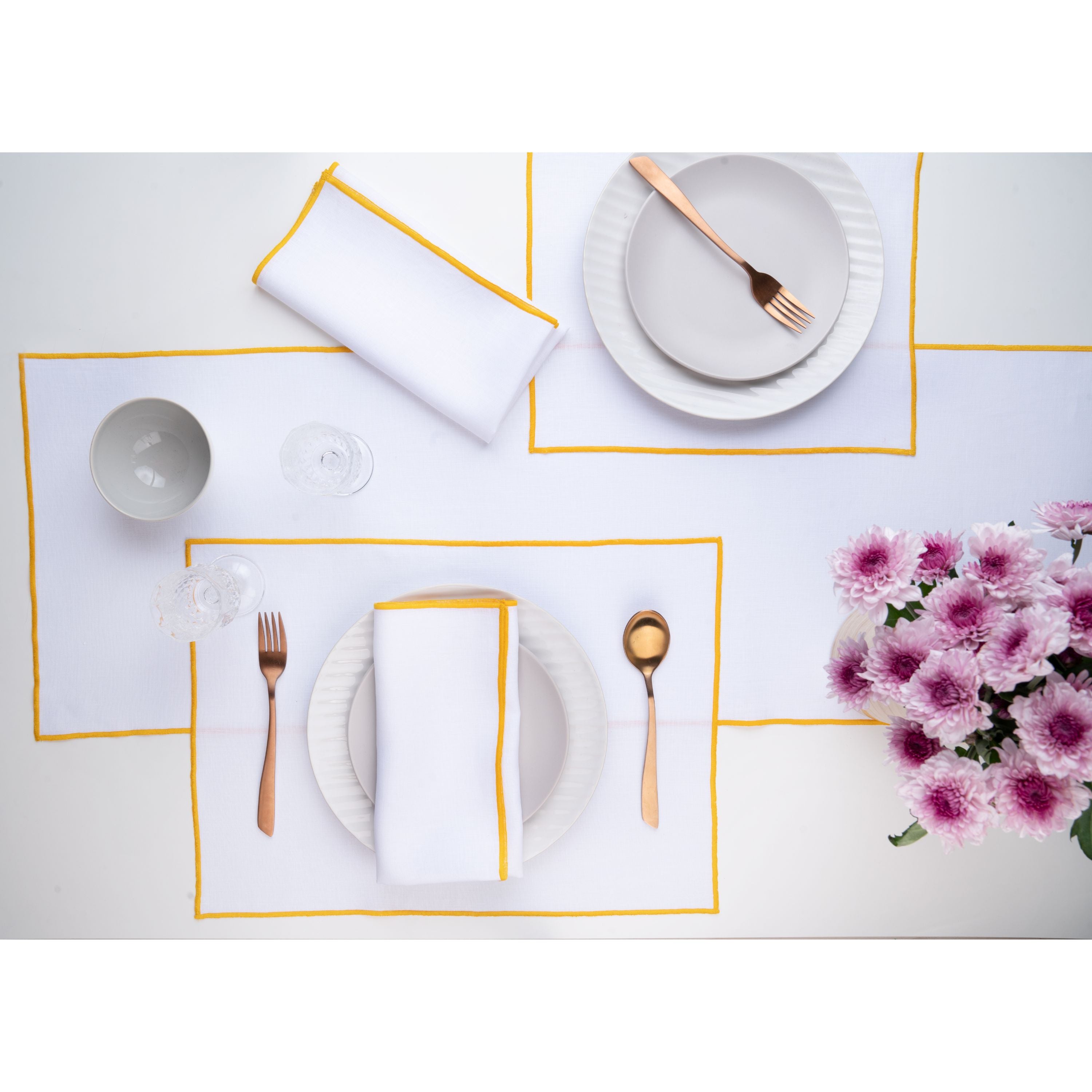 White and yellow pure linen placemats folded to show fabric texture