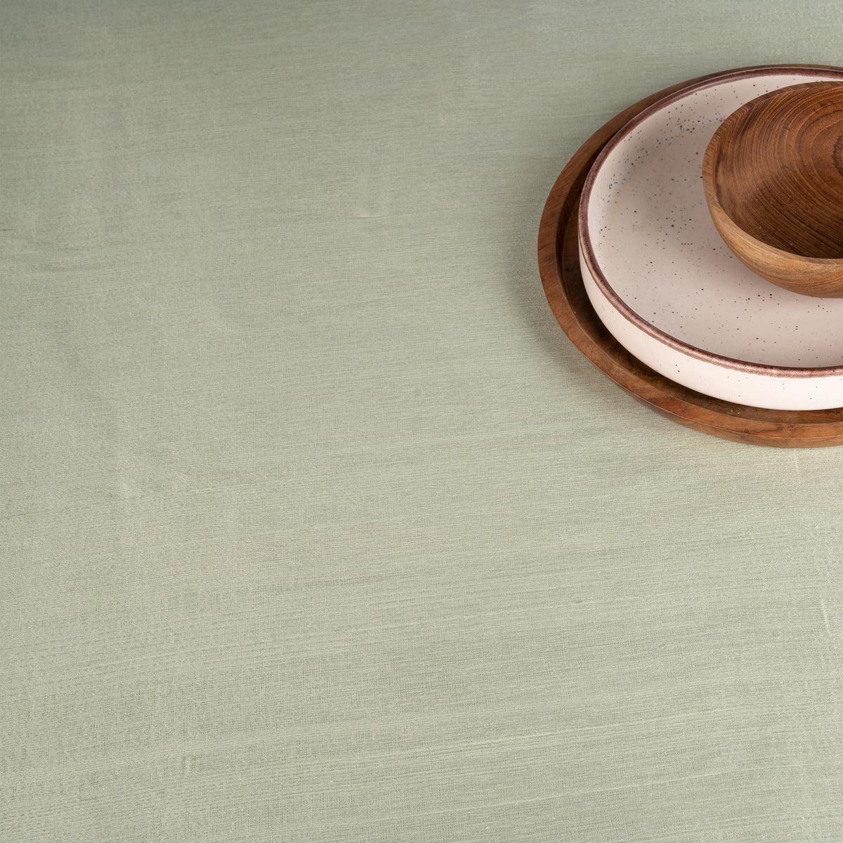 Sage green Luxe Shine tablecloth with matching D'Moksha table linens