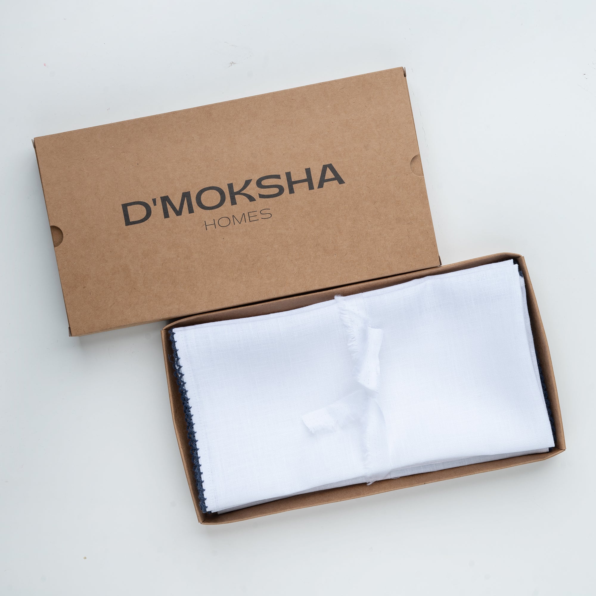 White and navy blue pure linen dinner napkins with matching D'Moksha table linens