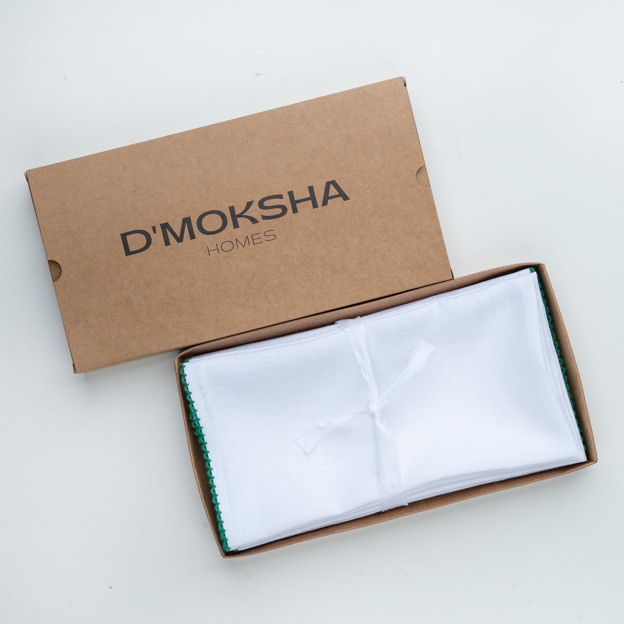 White and green pure linen dinner napkins with matching D'Moksha table linens
