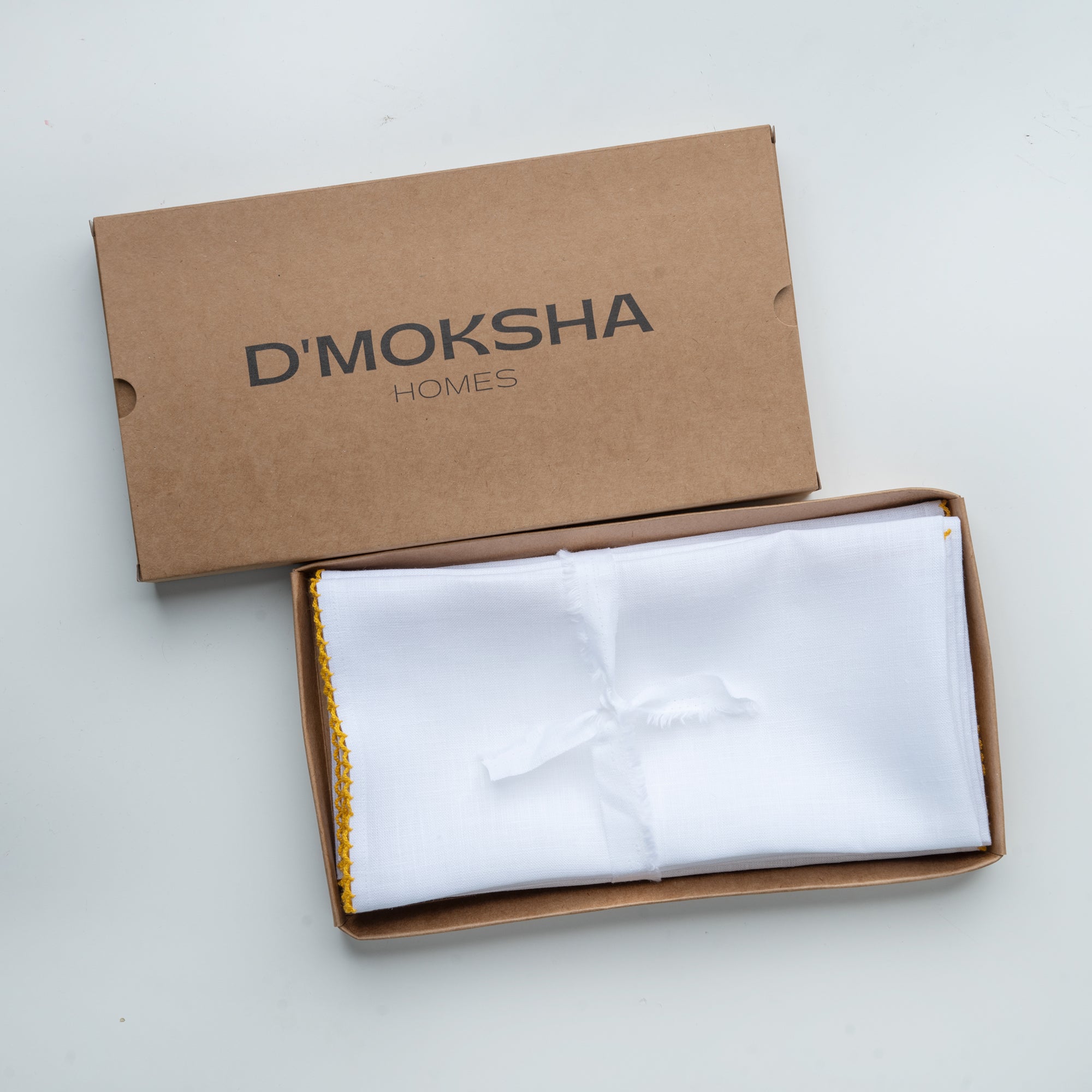 White and yellow pure linen dinner napkins with matching D'Moksha table linens