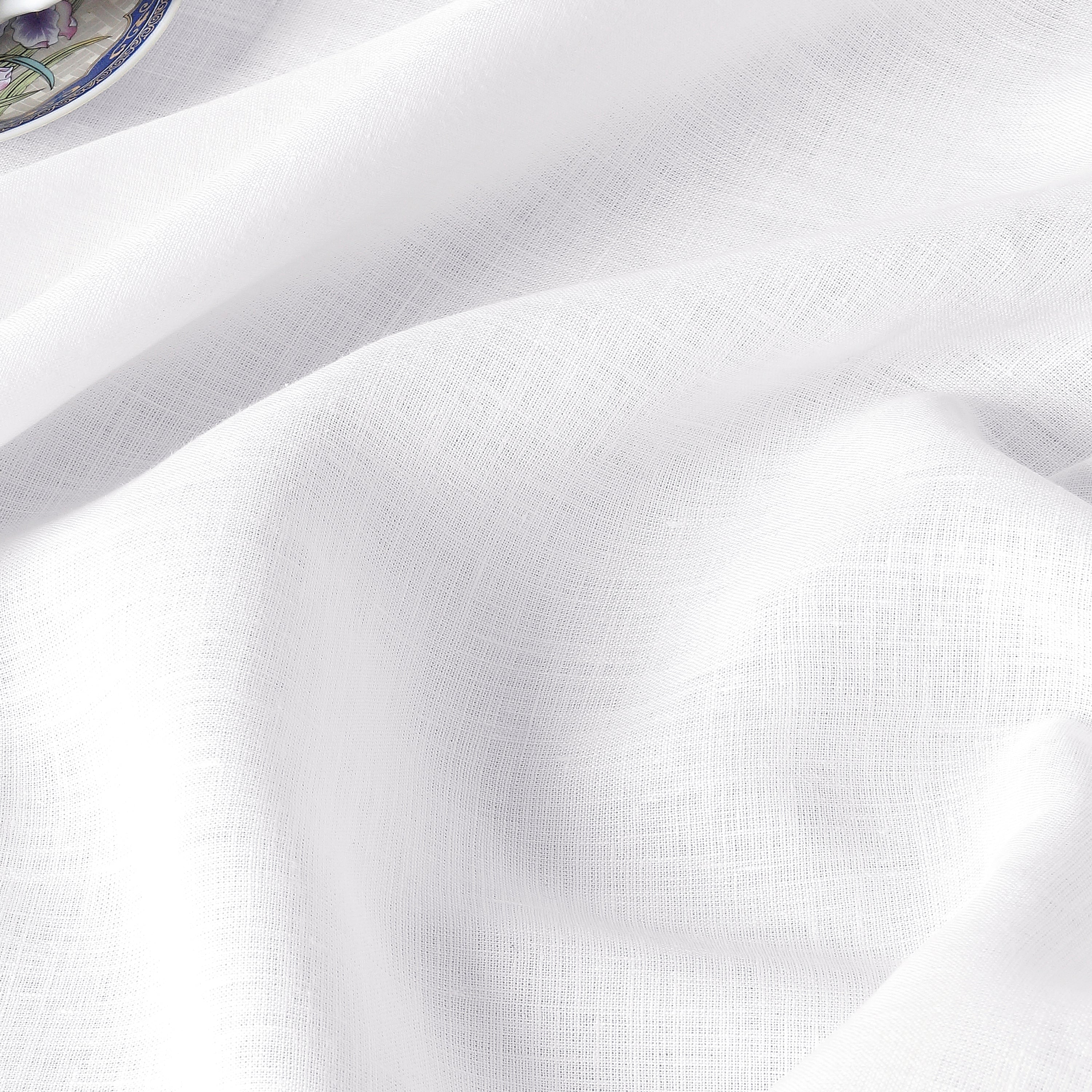 White linen tablecloth with matching D'Moksha table linens