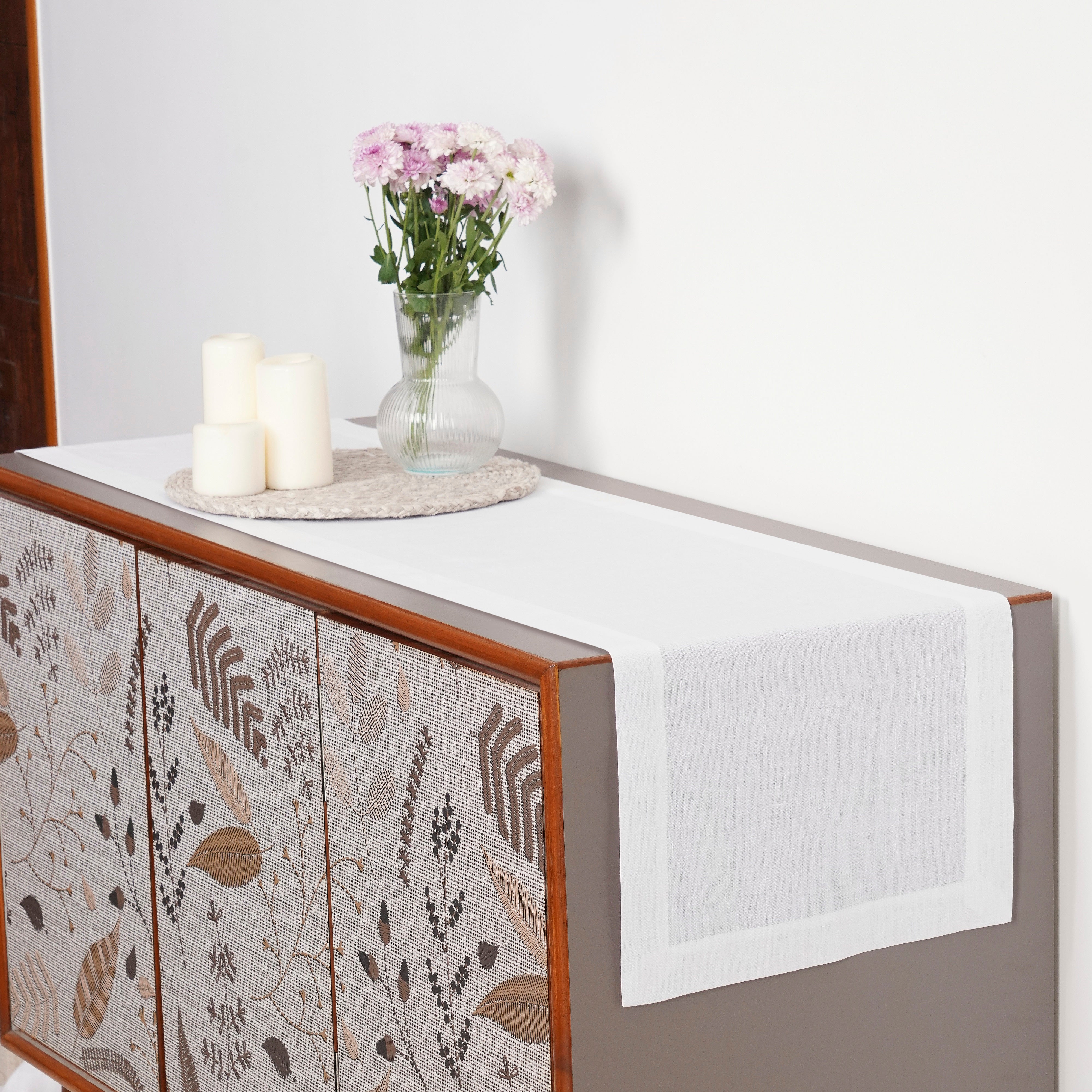 White linen table runner with matching D'Moksha table linens