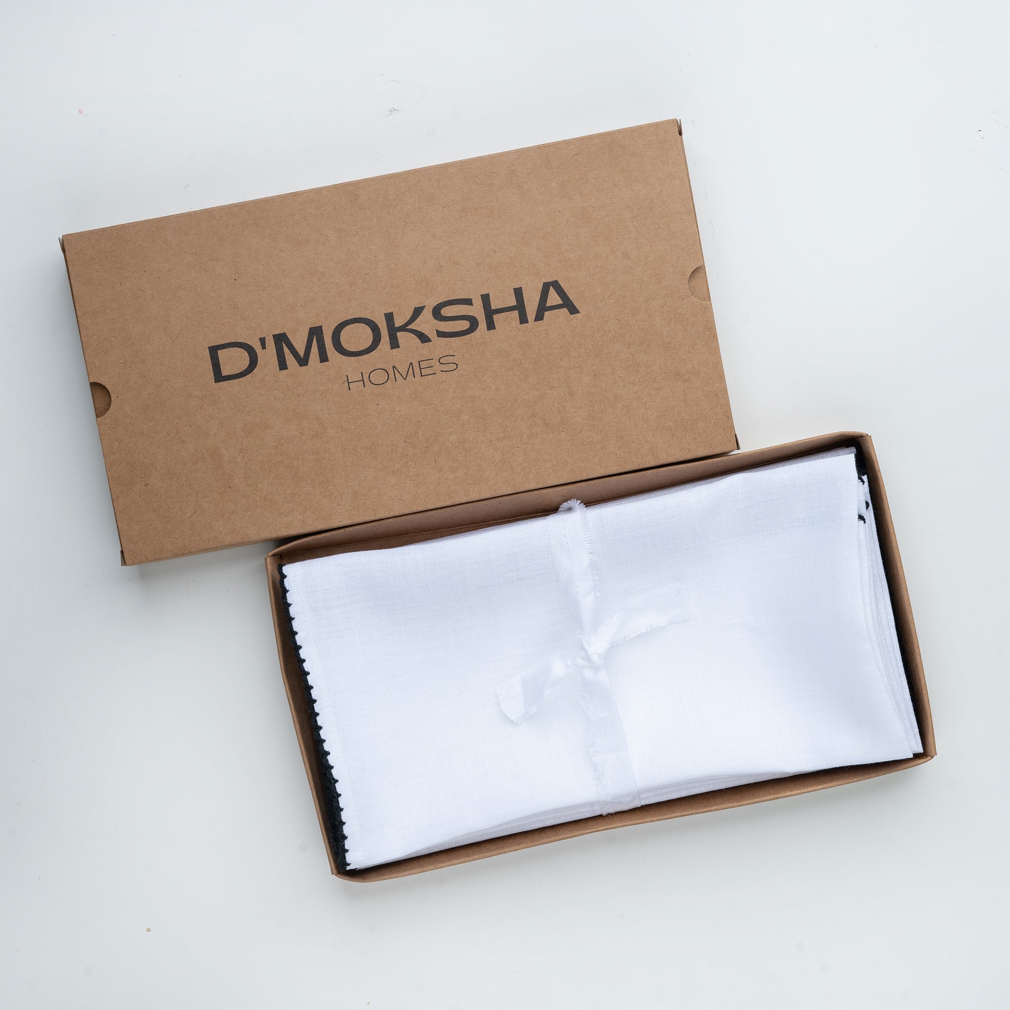 White and black pure linen dinner napkins folded to show fabric texture
