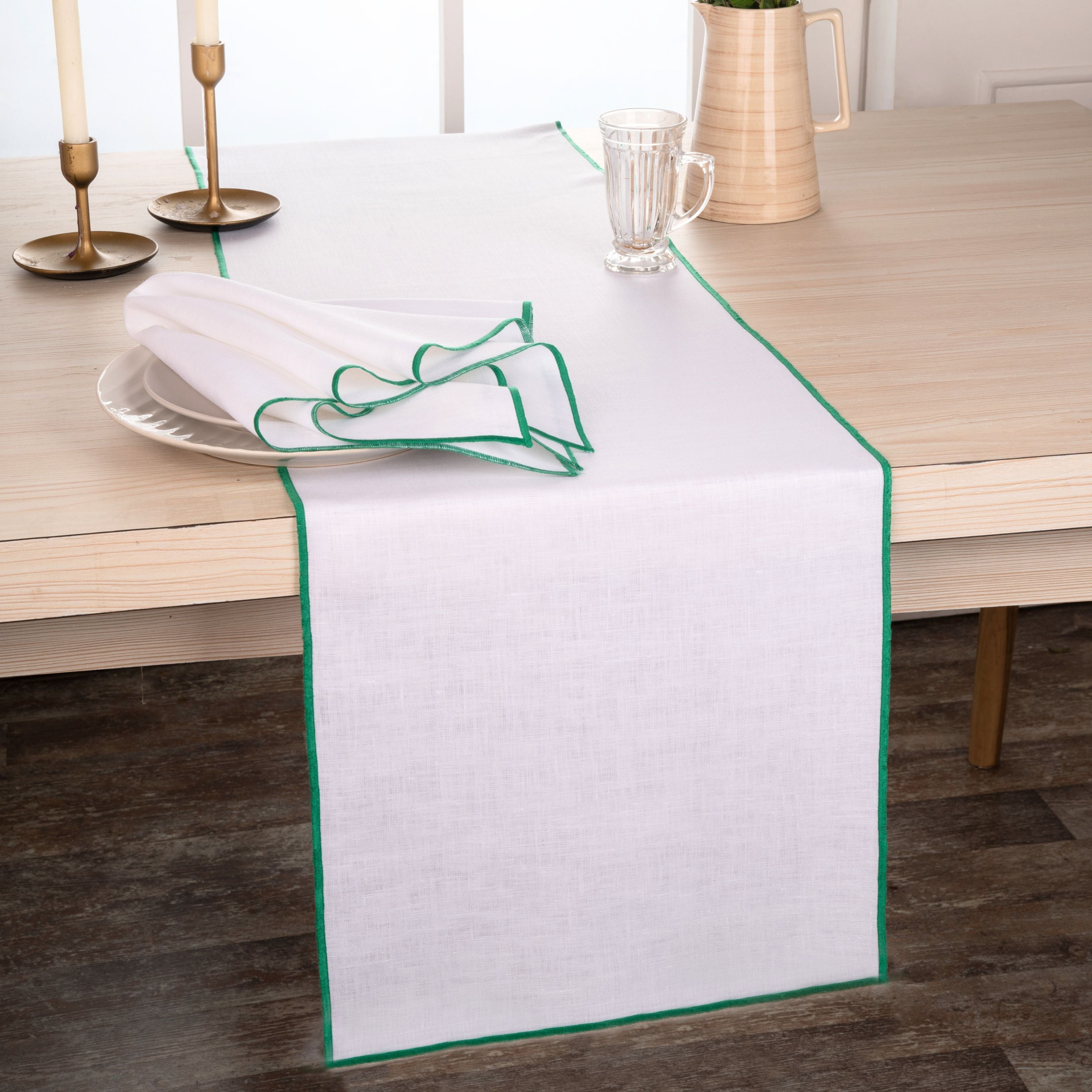 Close-up of the marrow edge on a white and green pure linen table runner