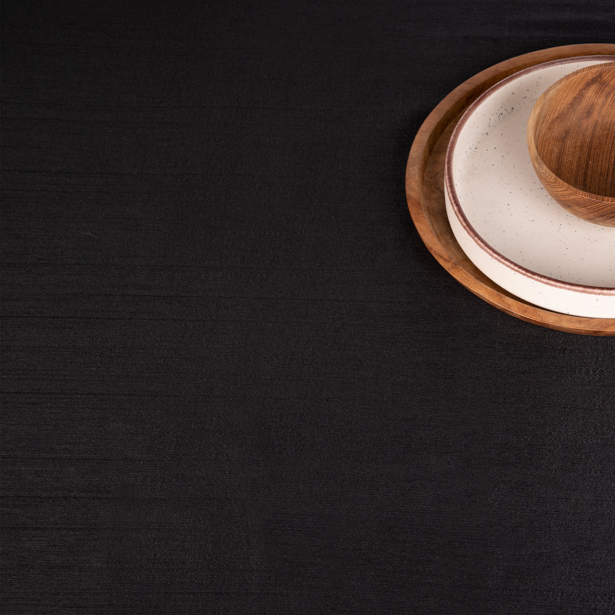 Black Luxe Shine tablecloth with matching D'Moksha table linens