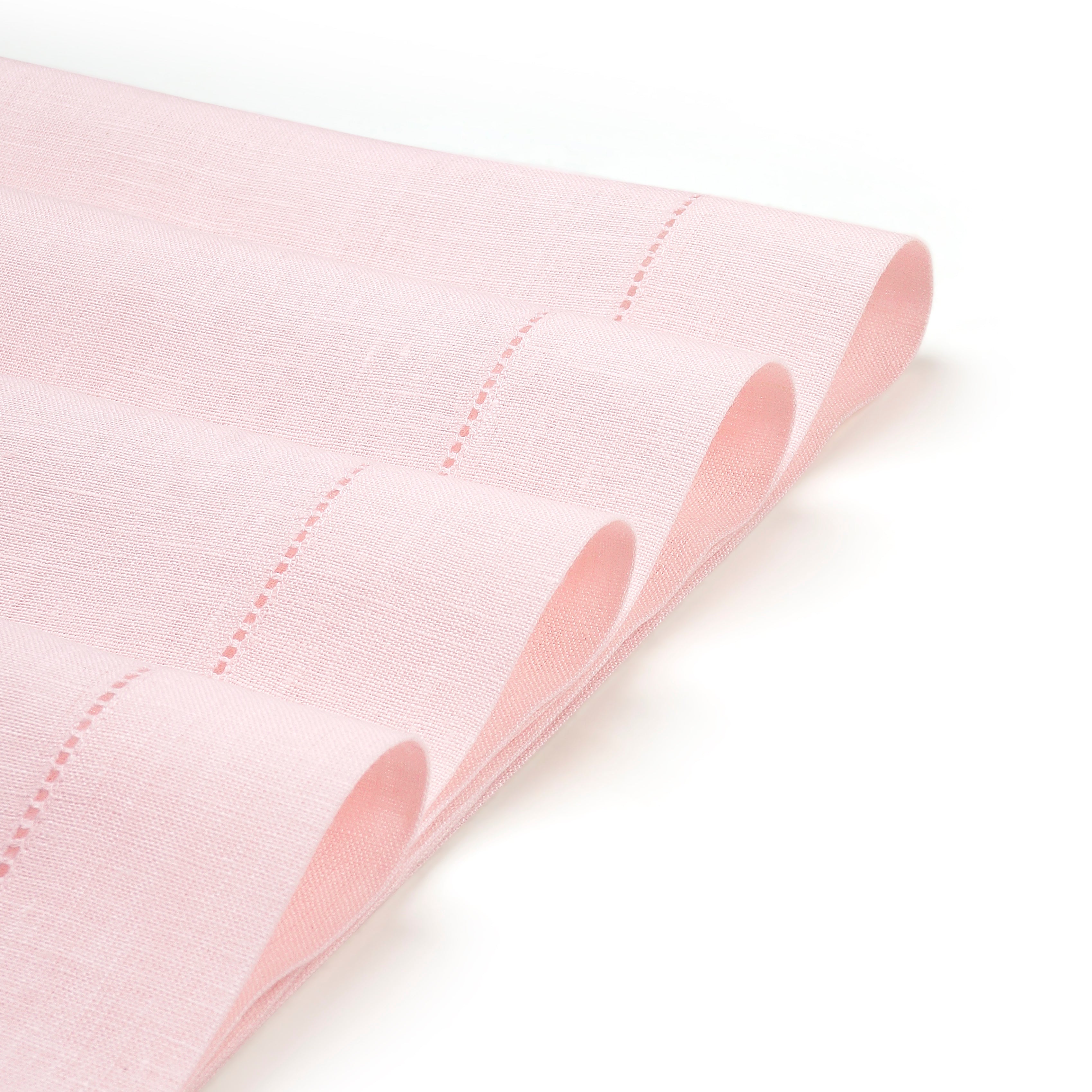 Pastel pink linen placemats with matching D'Moksha table linens