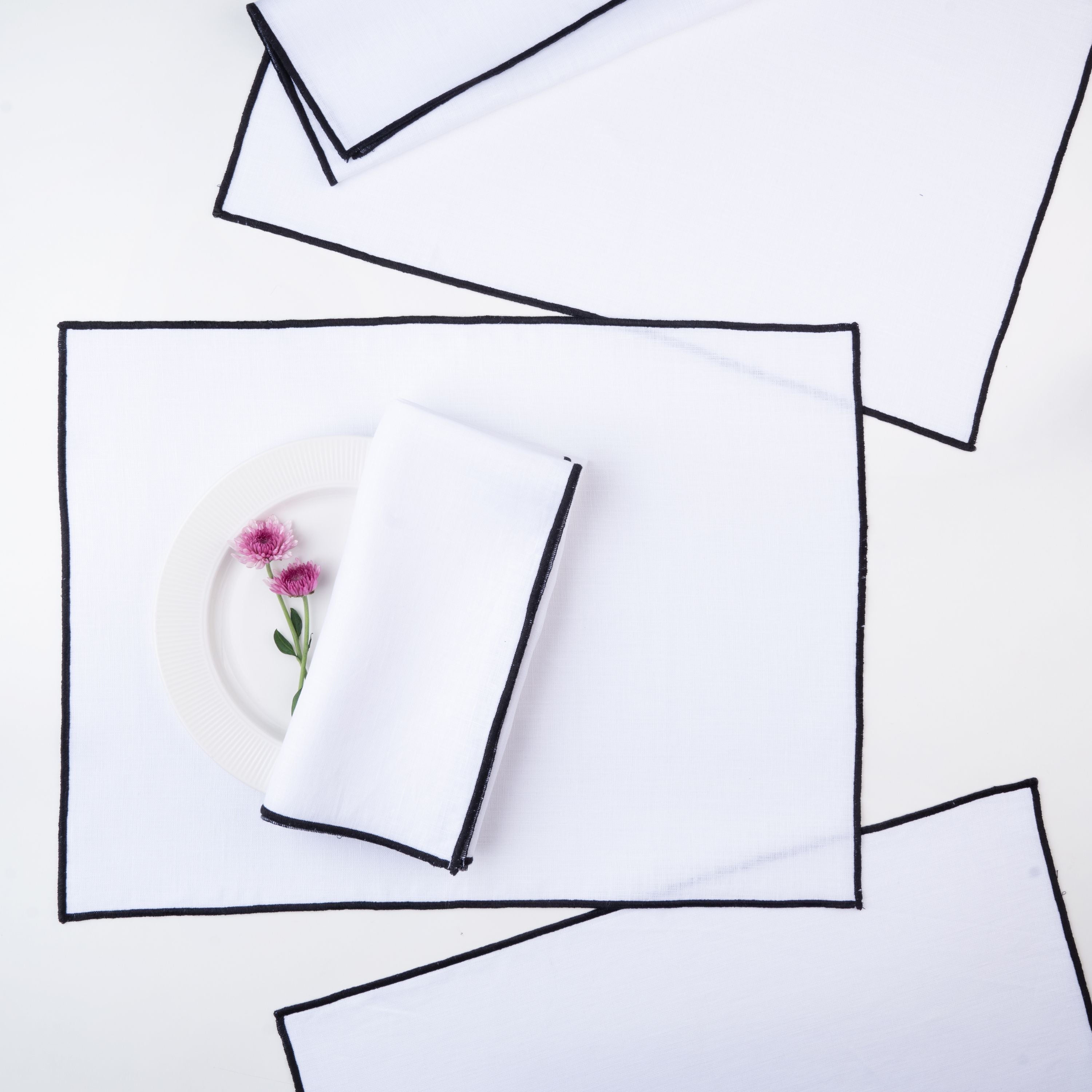 White and black pure linen placemats with matching D'Moksha table linens
