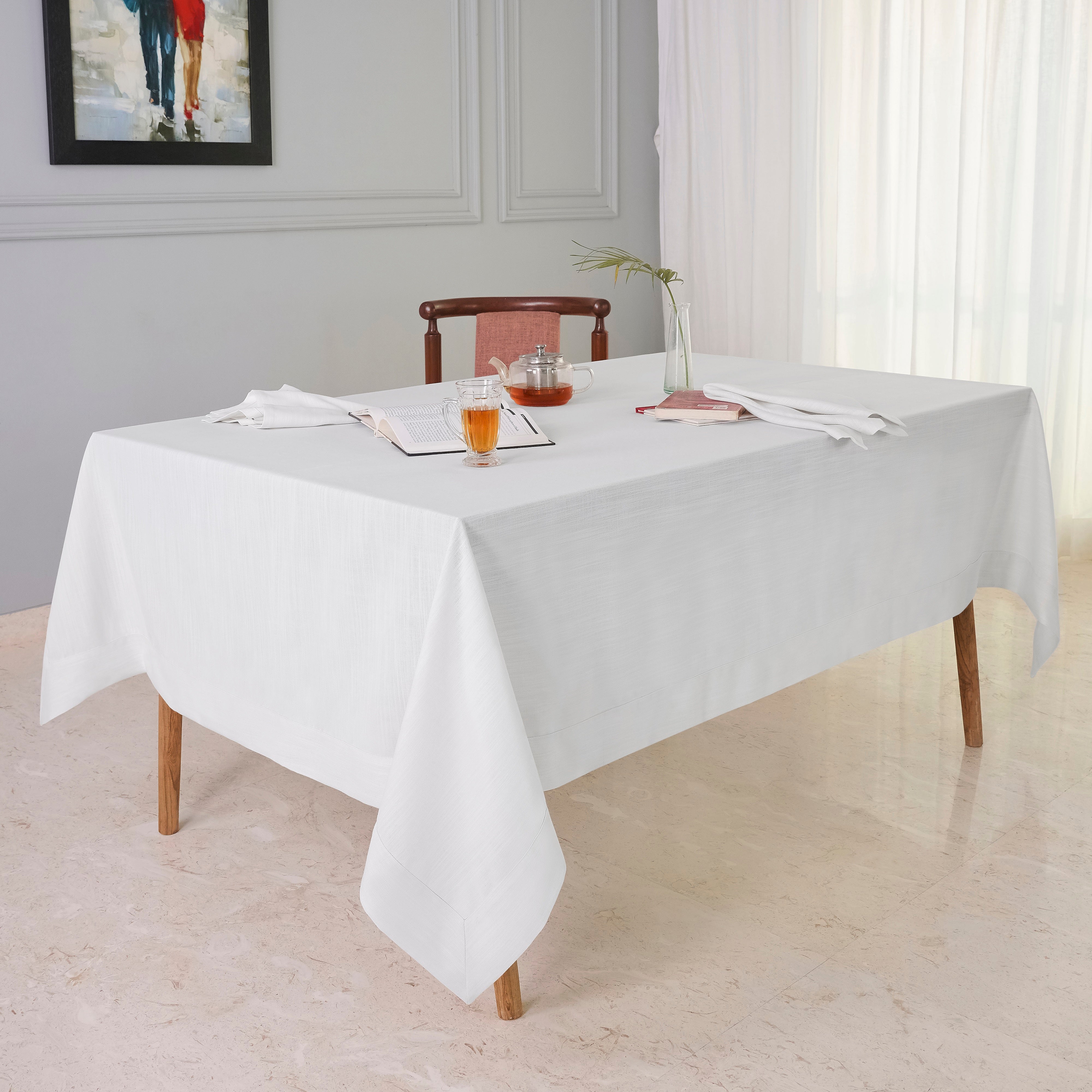 Chambray cream and white faux linen tablecloth folded to show fabric texture
