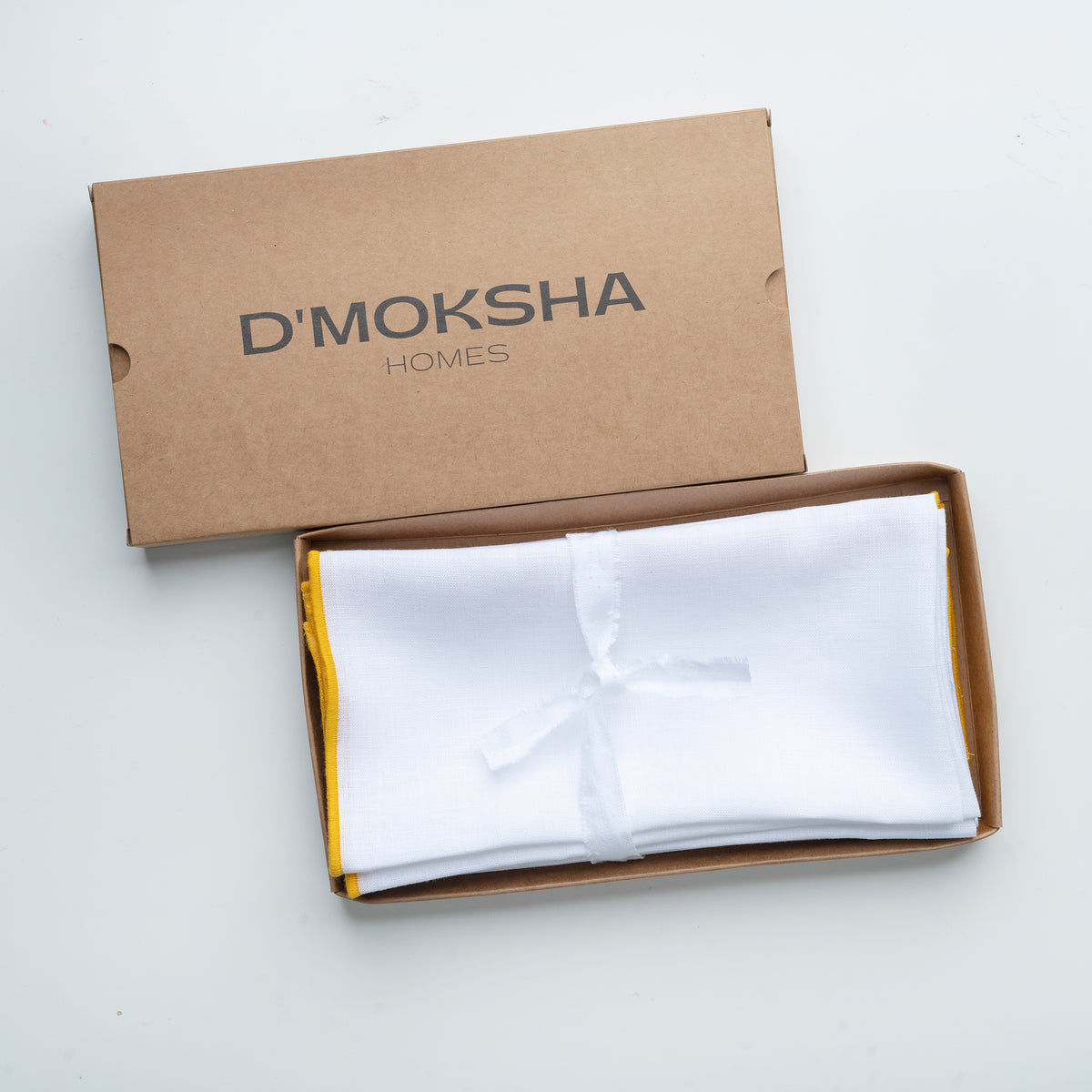 White and yellow pure linen dinner napkins in a set table setting