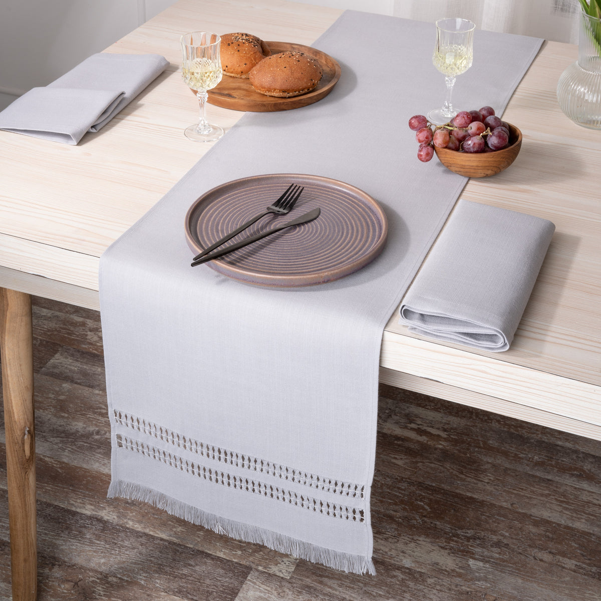 Light grey faux linen table runner folded to show fabric texture