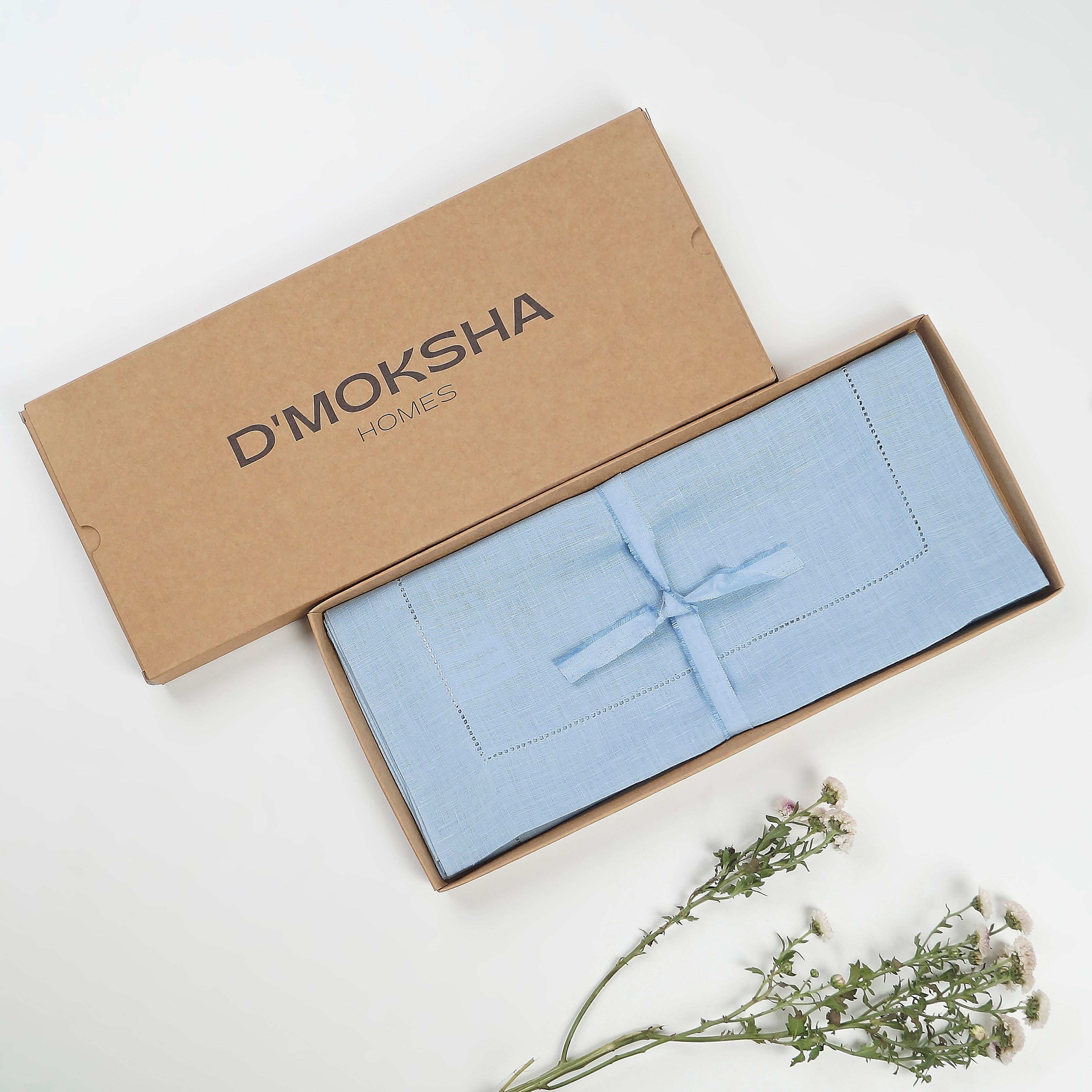 Powder blue pure linen table runner folded to show fabric texture