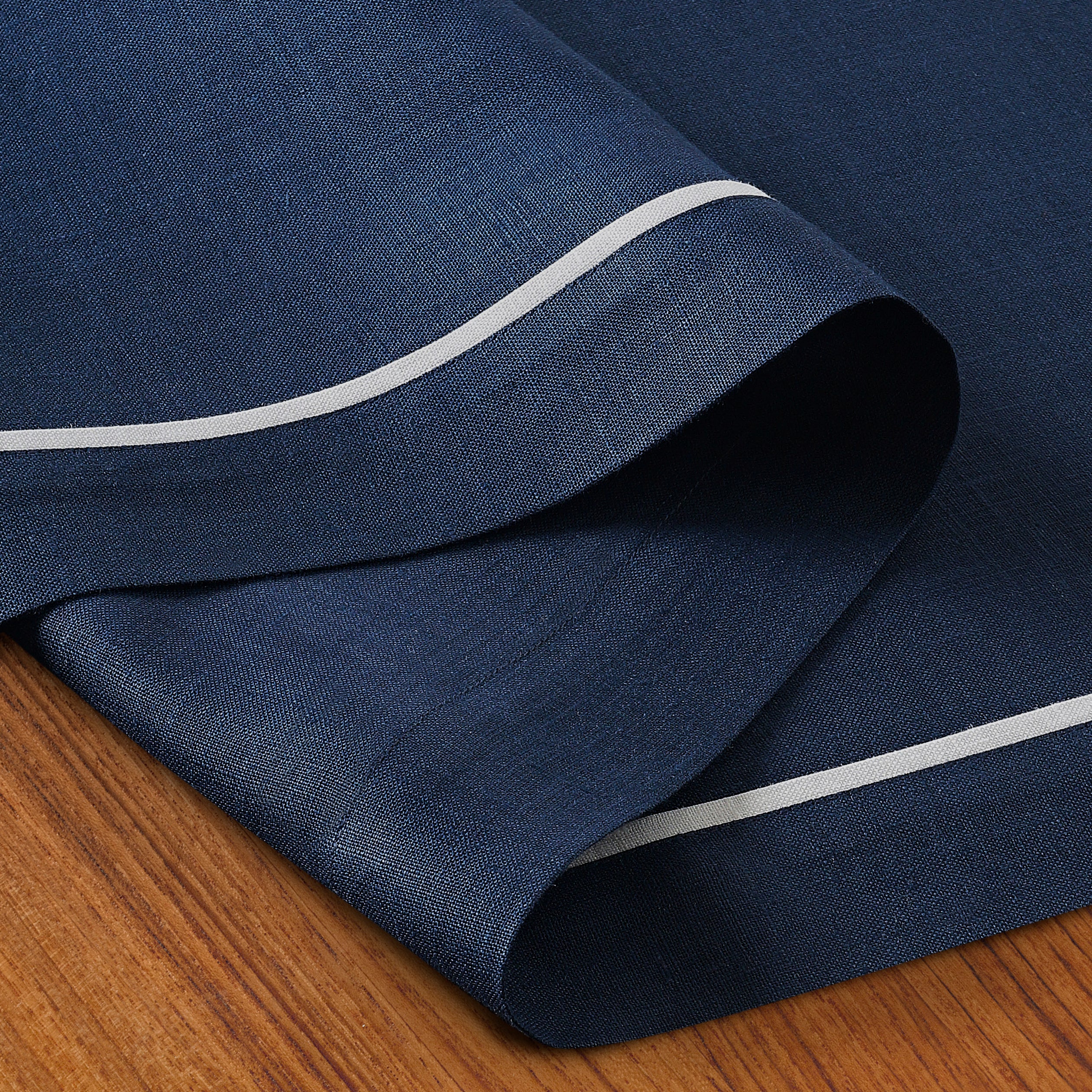 Navy blue and white pure linen table runner folded to show fabric texture