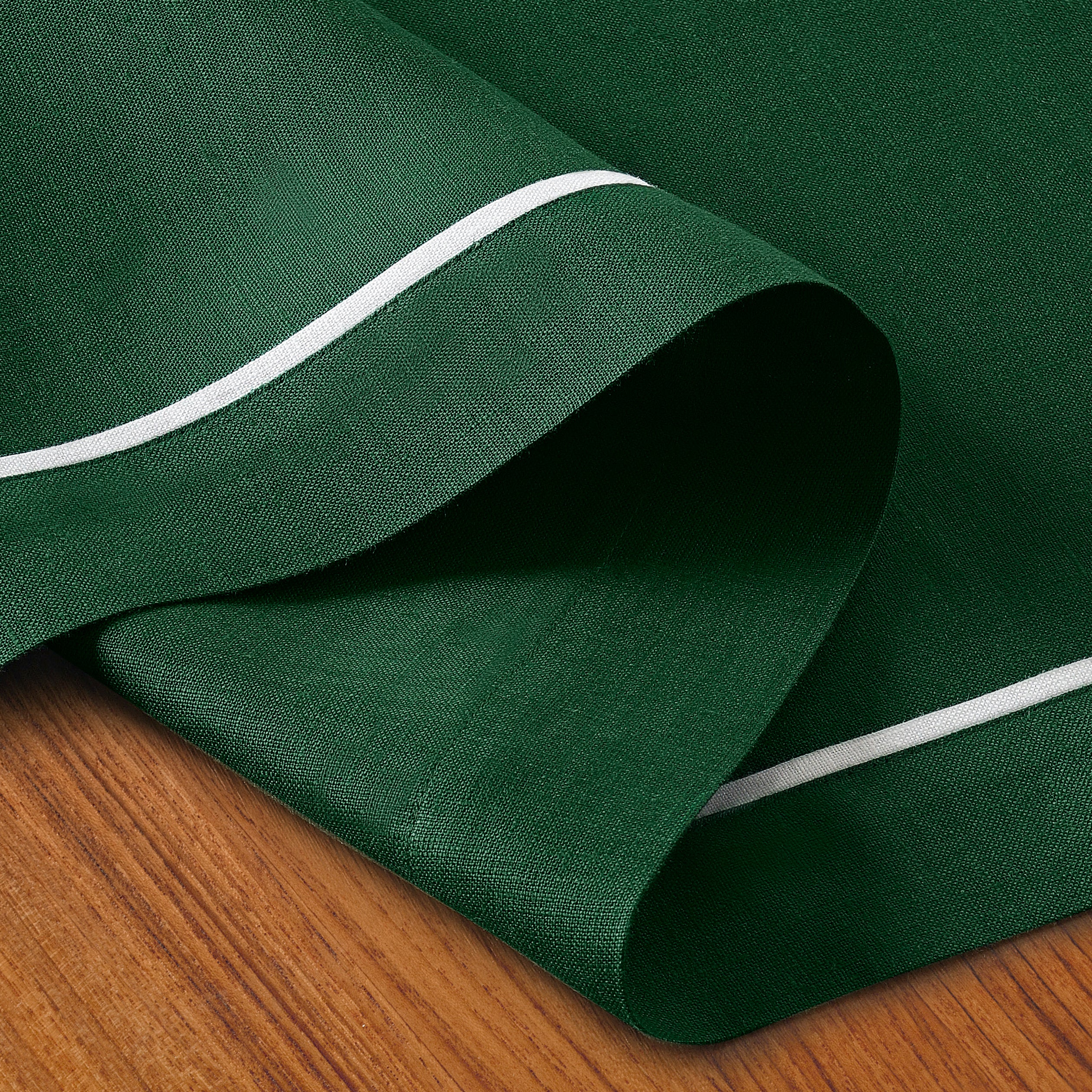 Forest green and white pure linen table runner folded to show fabric texture