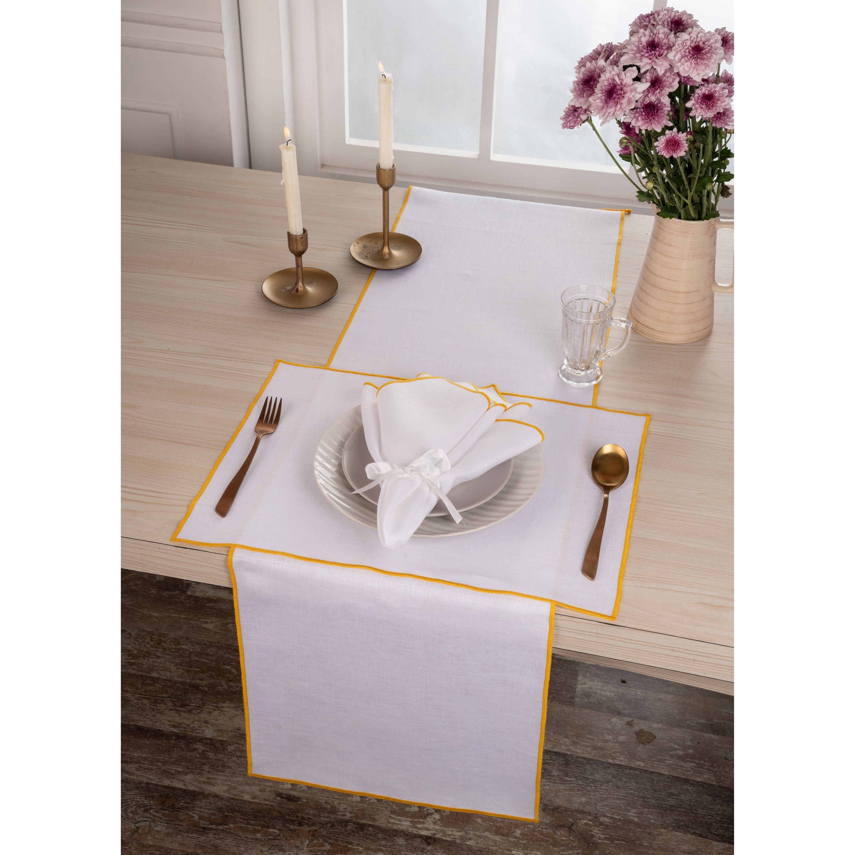 Close-up of the marrow edge on white and yellow pure linen placemats