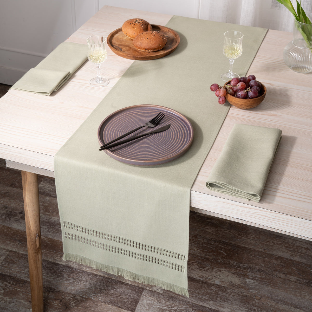 Sage green faux linen table runner folded to show fabric texture