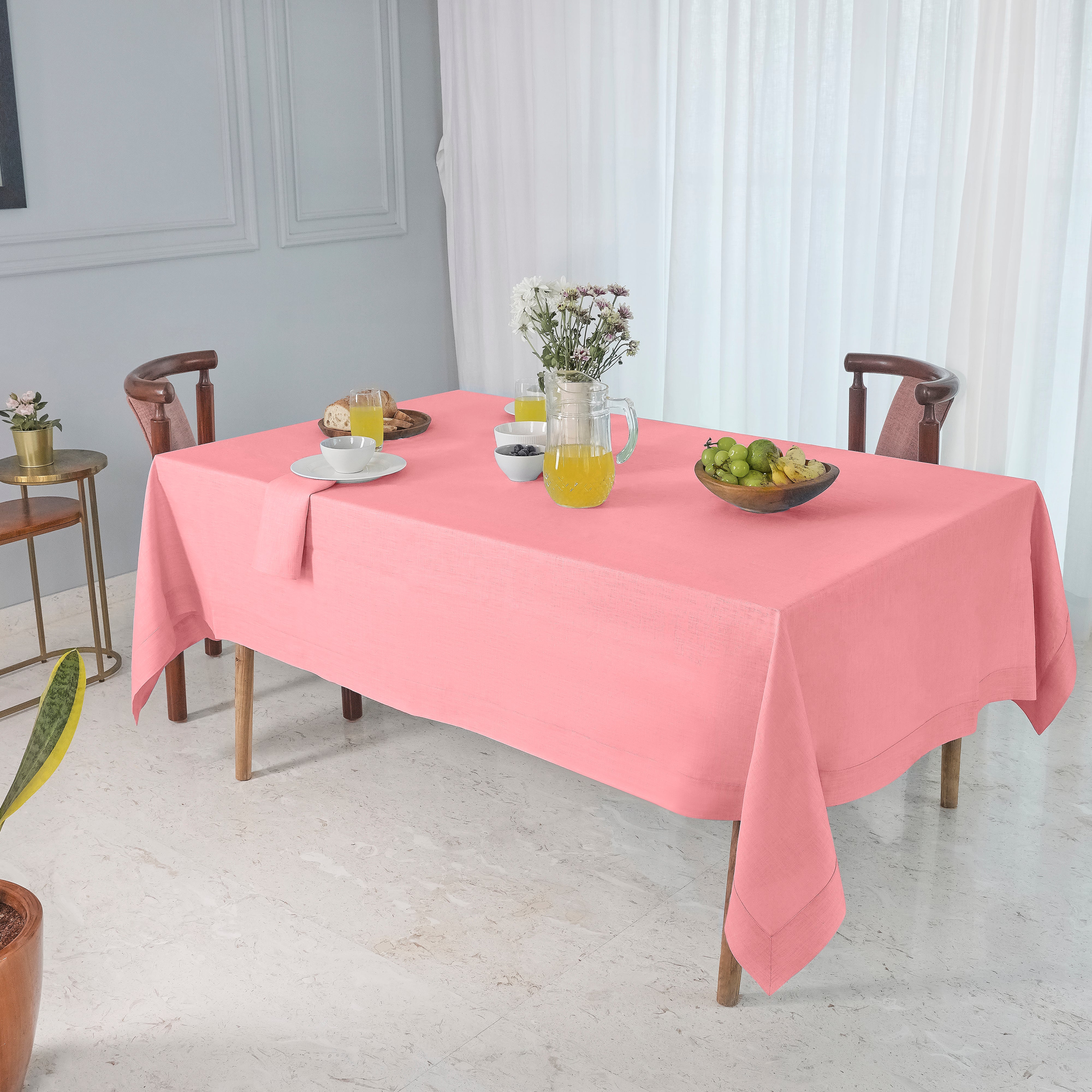 Dusty pink pure linen tablecloth folded to show fabric texture