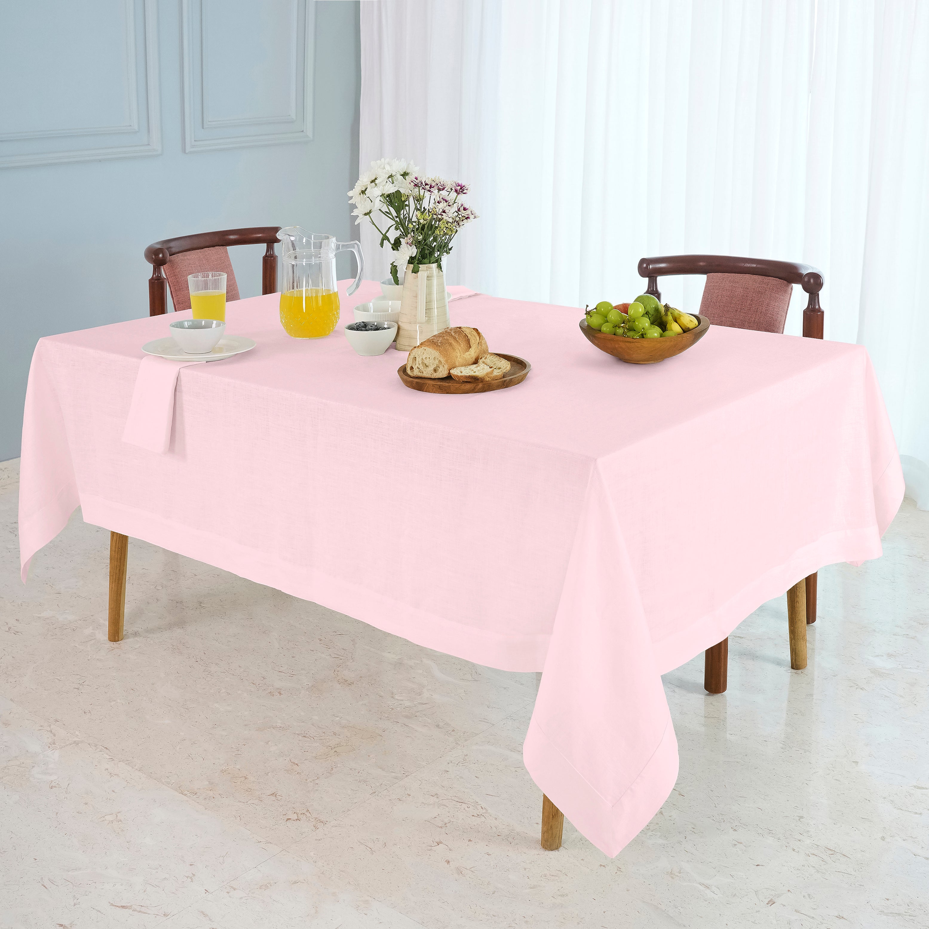 Pastel pink pure linen tablecloth folded to show fabric texture