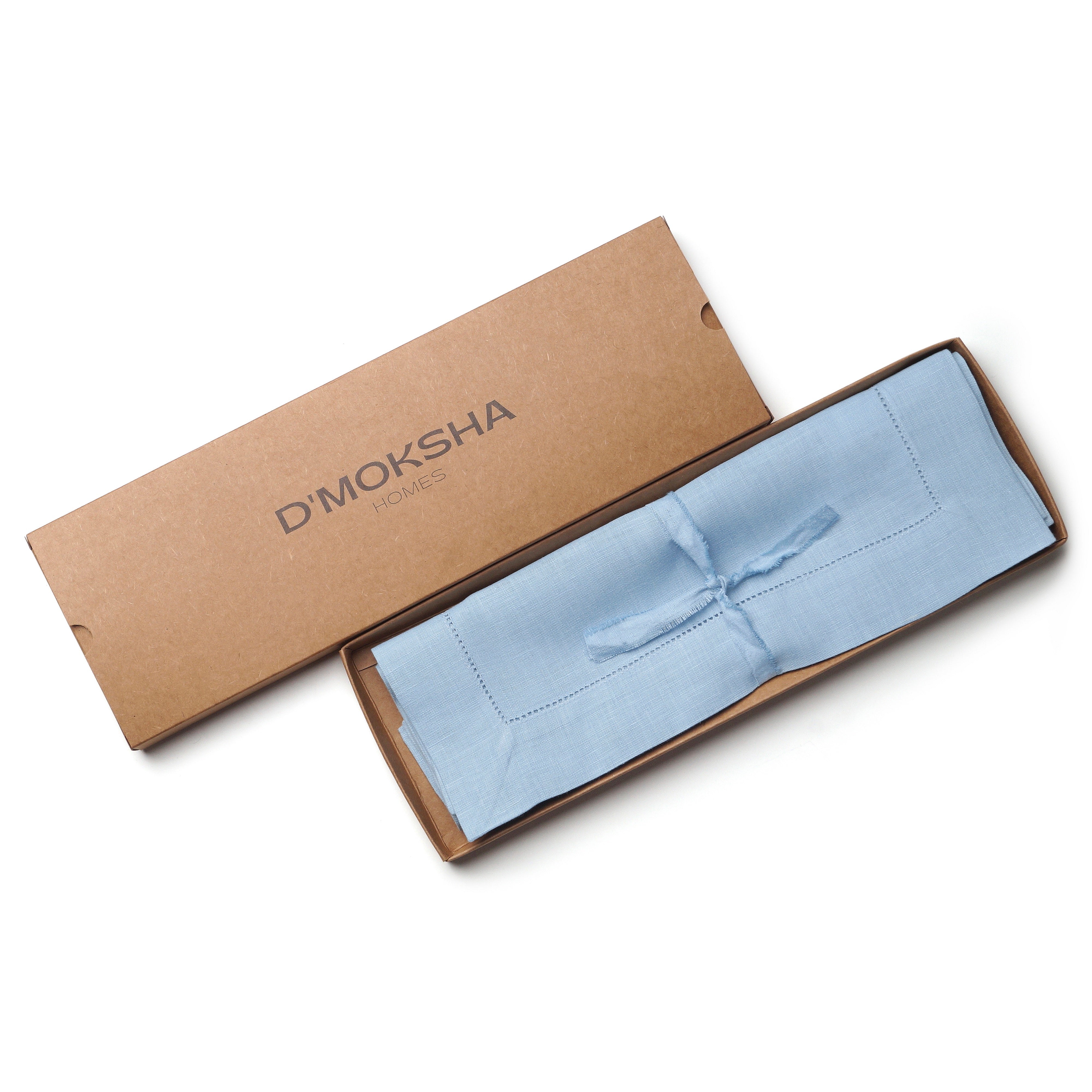 Powder blue pure linen placemats folded to show fabric texture
