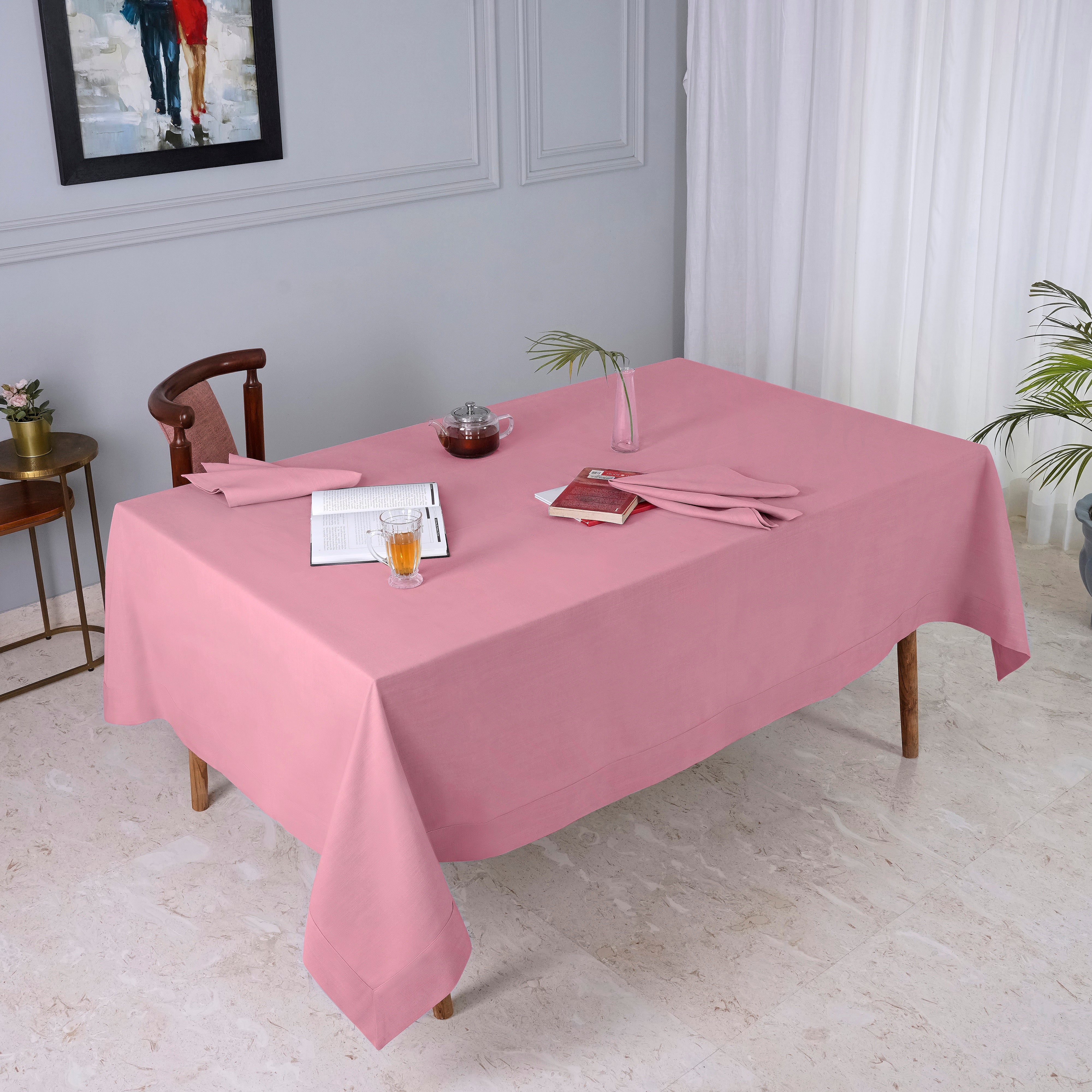 Dusty pink faux linen tablecloth folded to show fabric texture