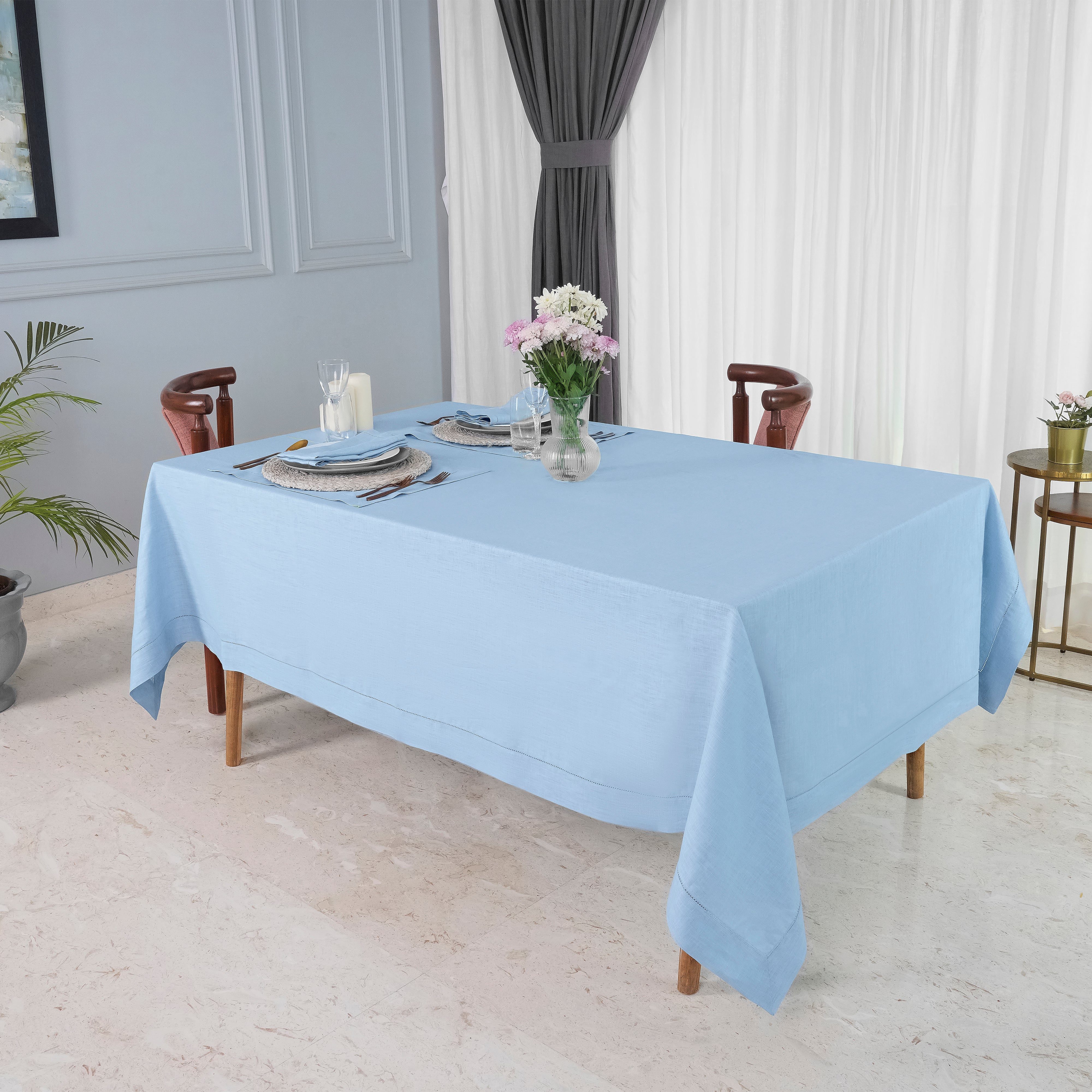 Powder blue pure linen tablecloth folded to show fabric texture