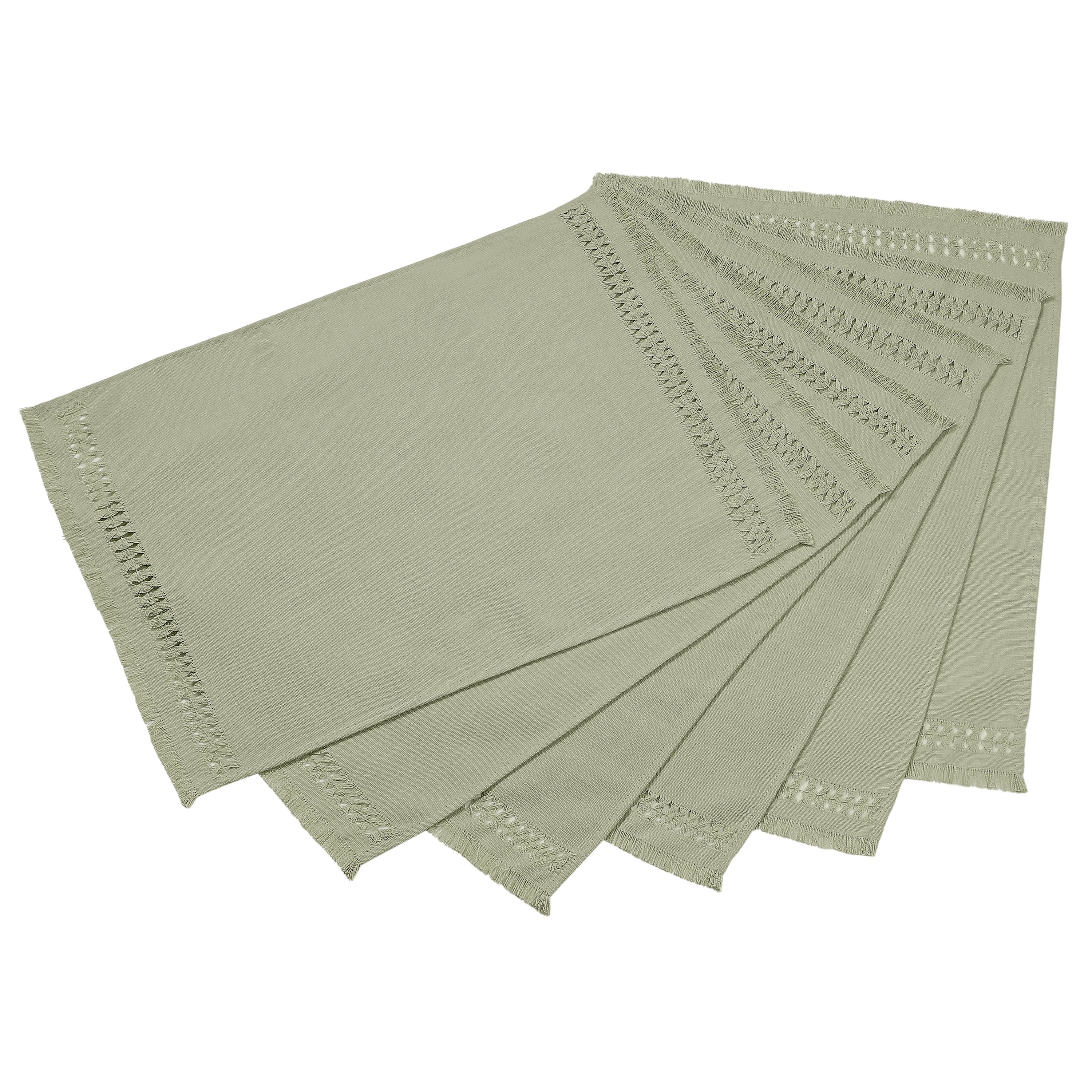 Sage green faux linen placemats folded to show fabric texture