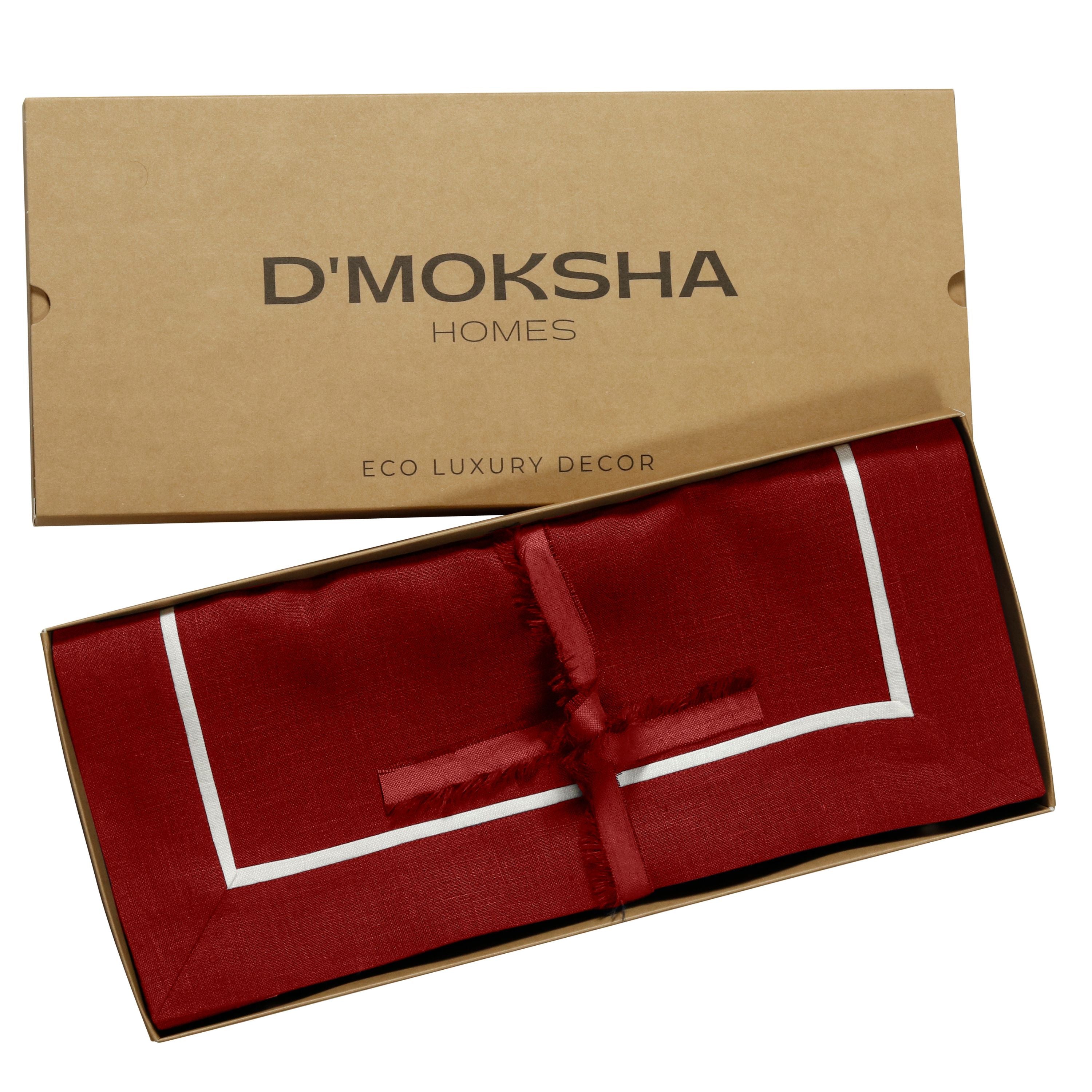 Red and white pure linen placemats folded to show fabric texture