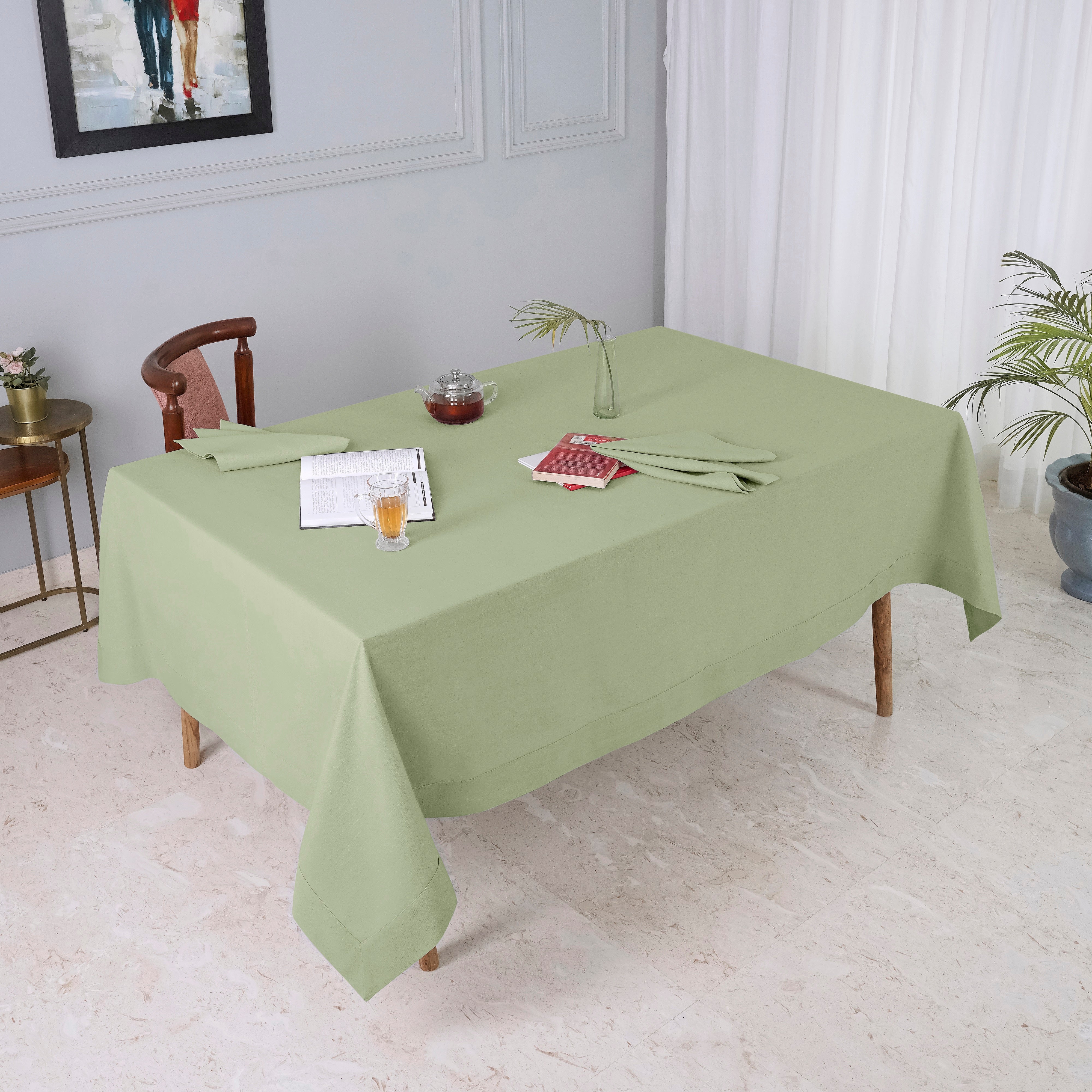 Sage green faux linen tablecloth folded to show fabric texture