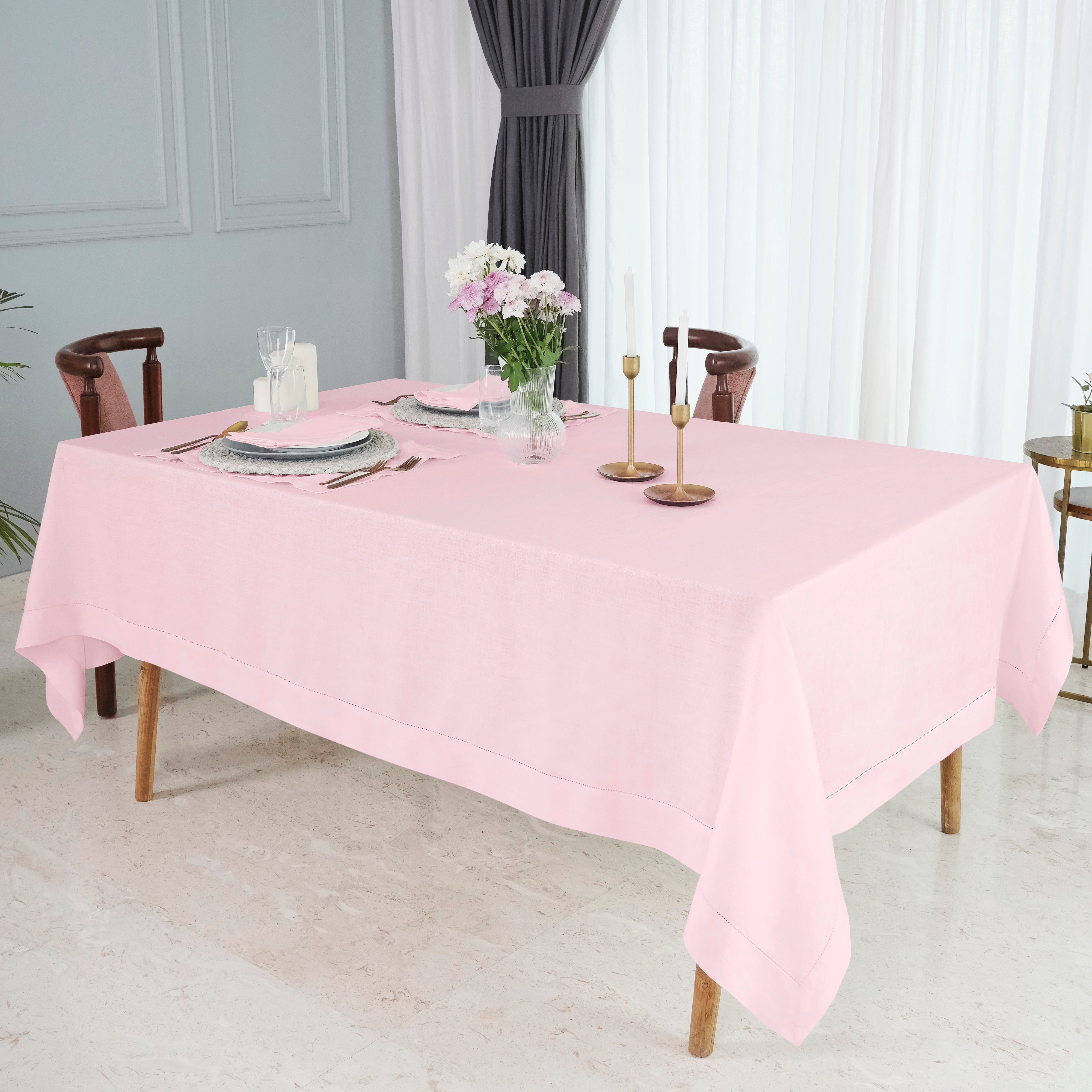 Pastel pink pure linen tablecloth folded to show fabric texture