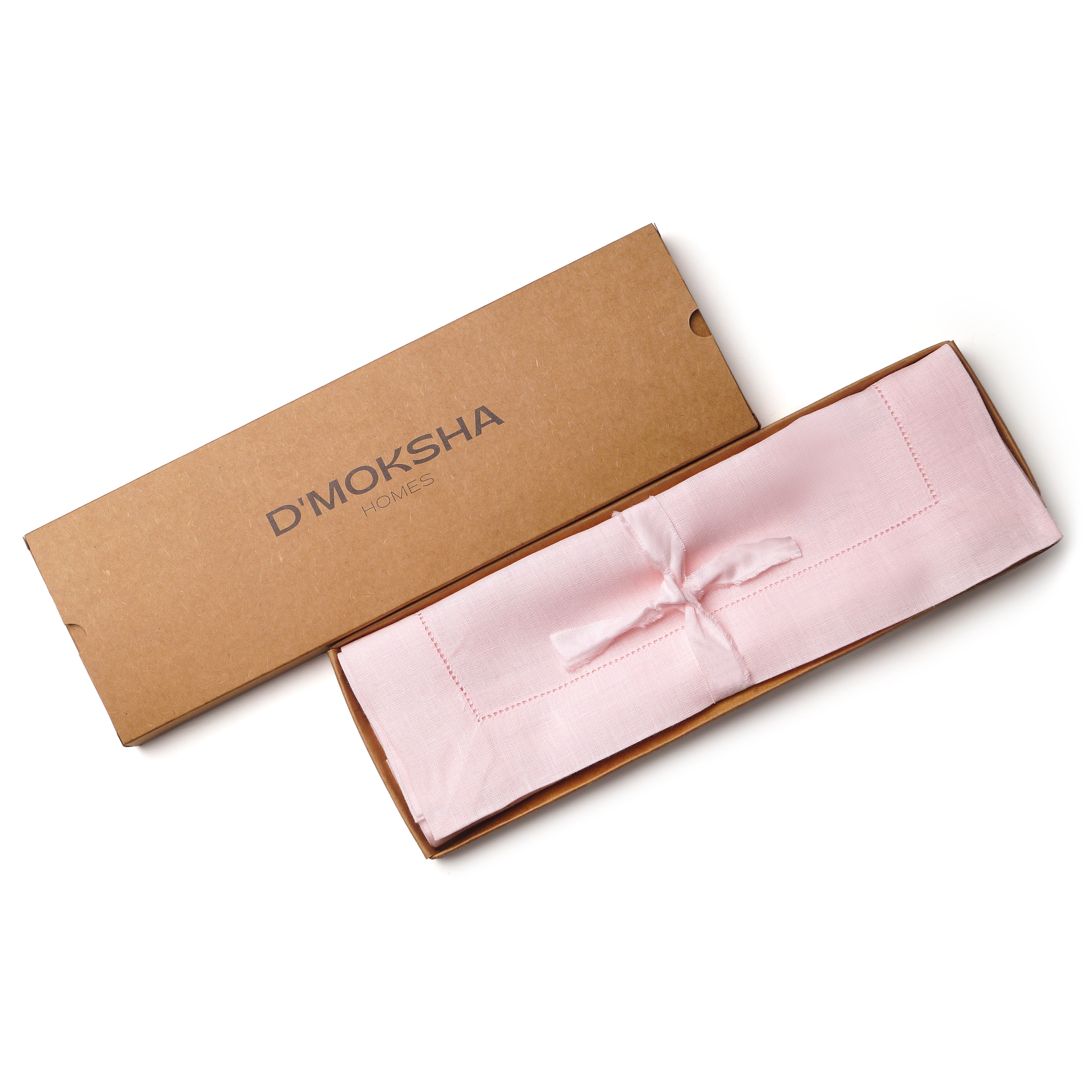 Pastel pink linen placemats folded to show fabric texture