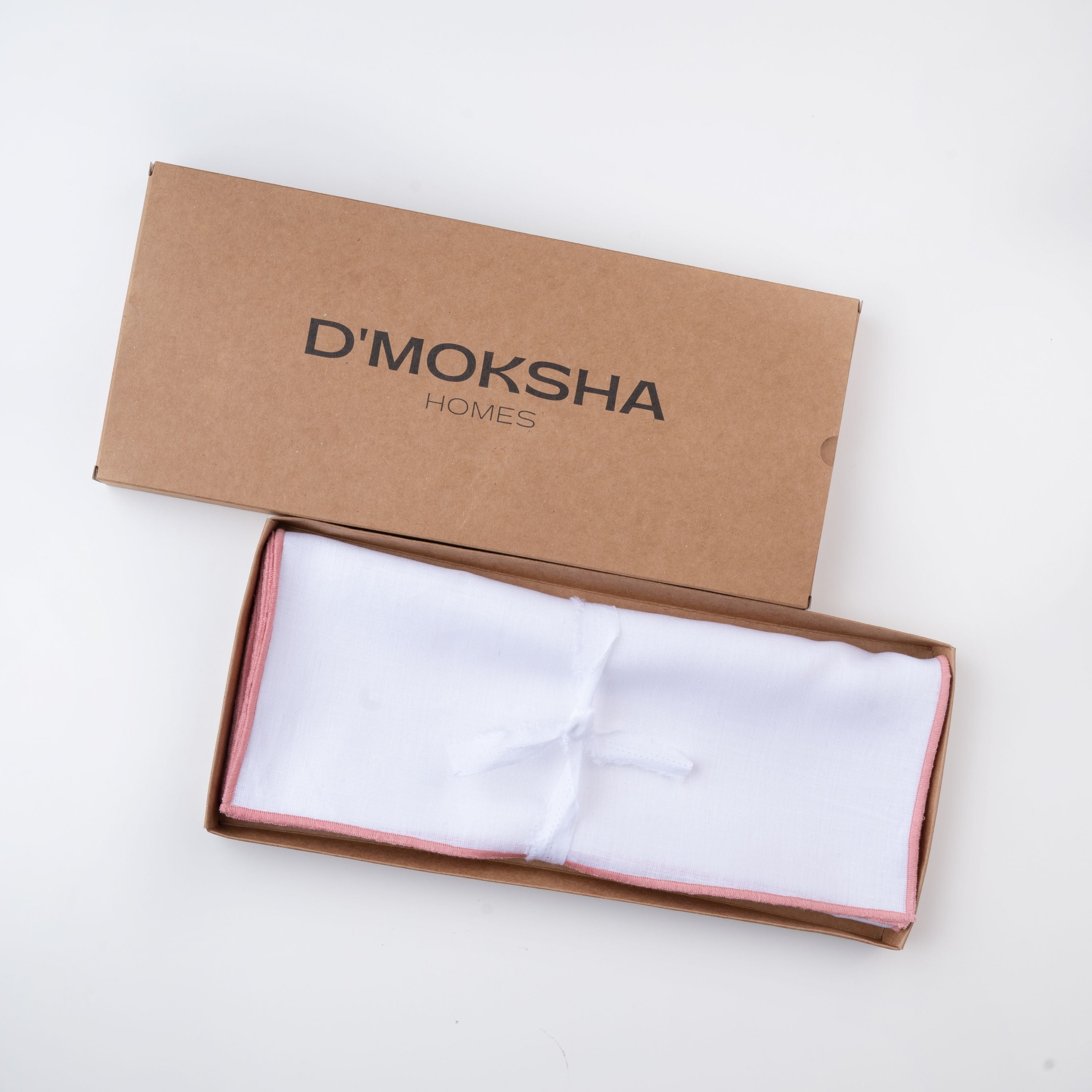 White and dusty pink pure linen placemats in a set table setting