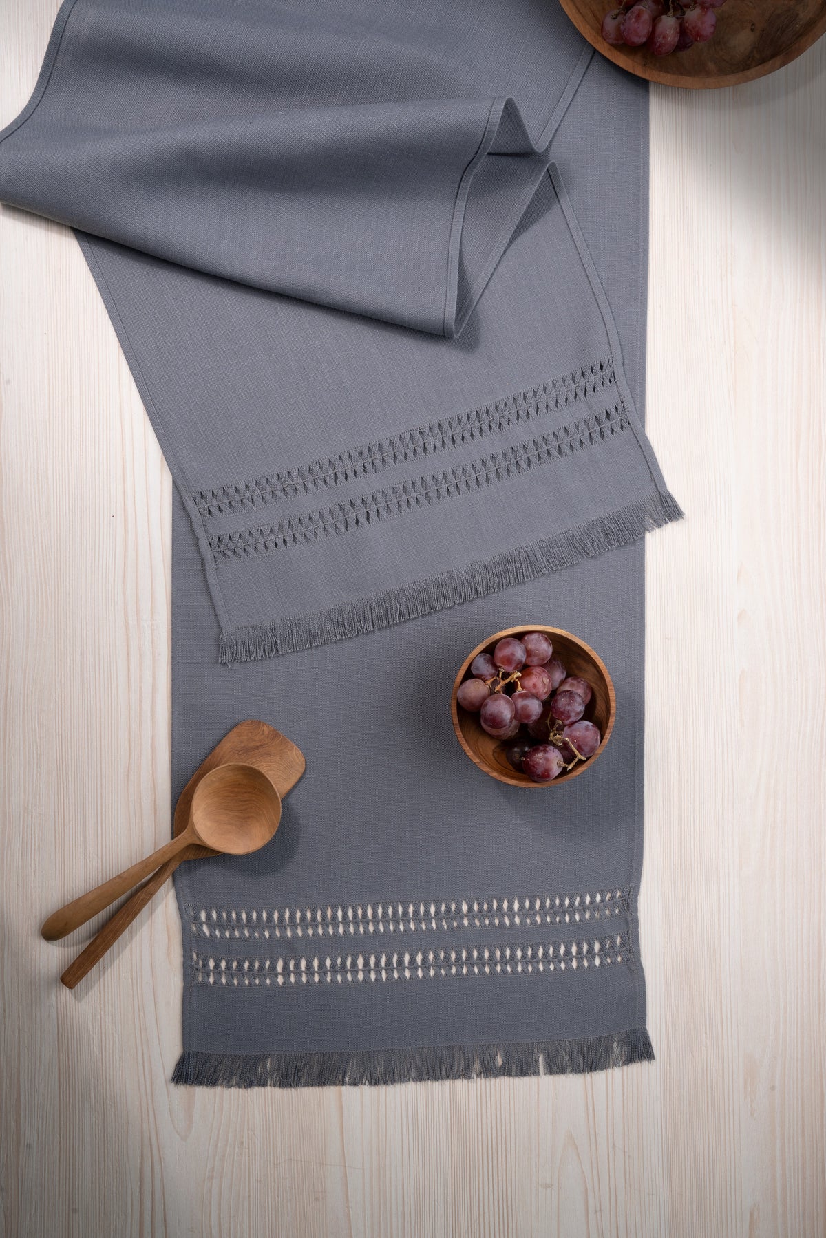 Charcoal grey faux linen table runner in a set table setting