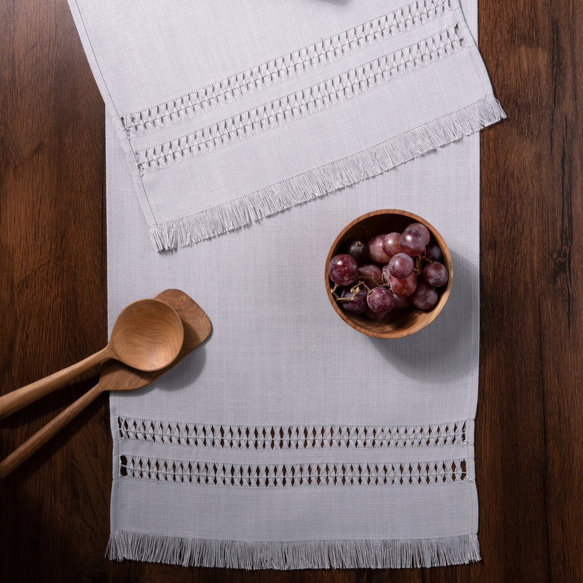 Light grey faux linen table runner in a set table setting