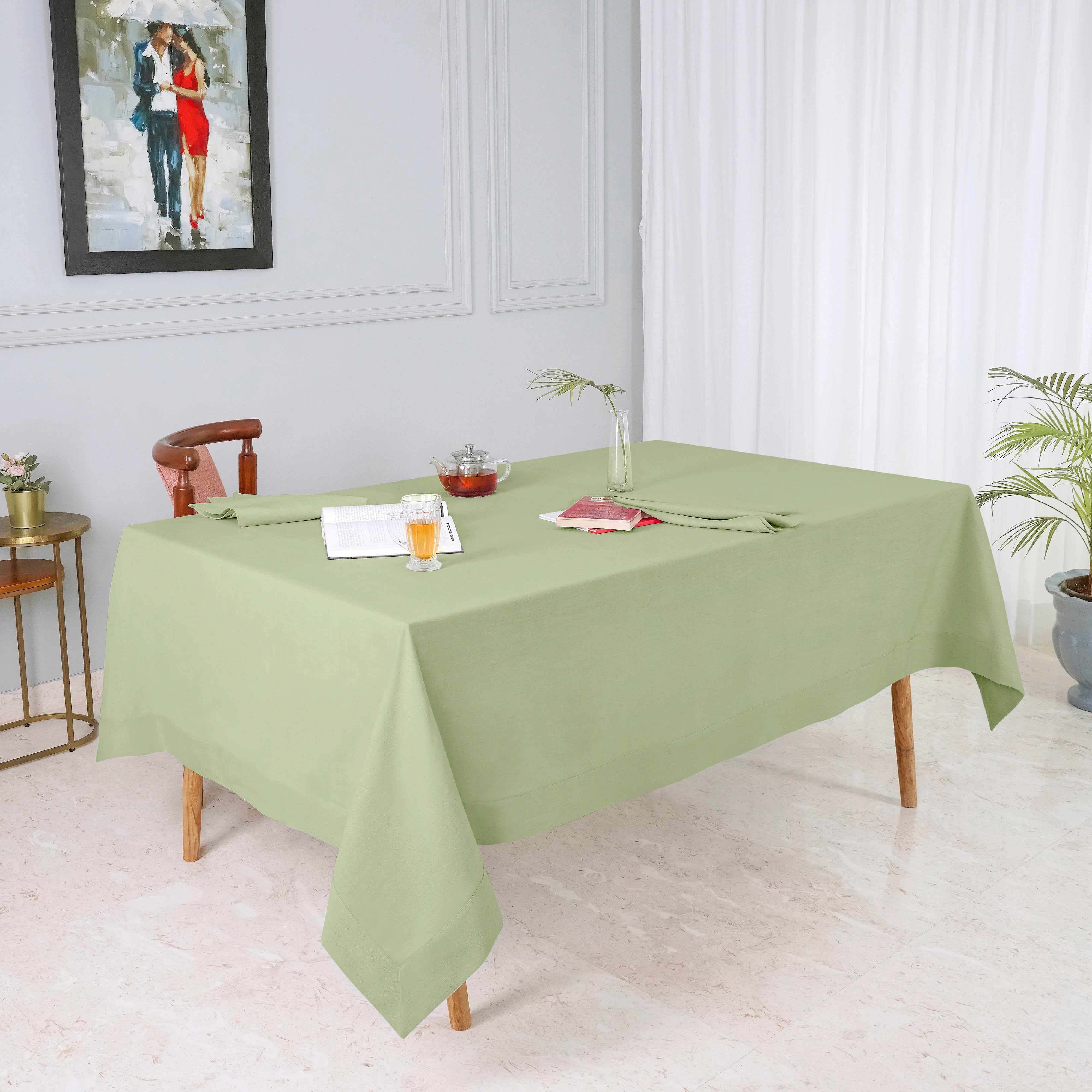 Sage green faux linen tablecloth in a set table setting