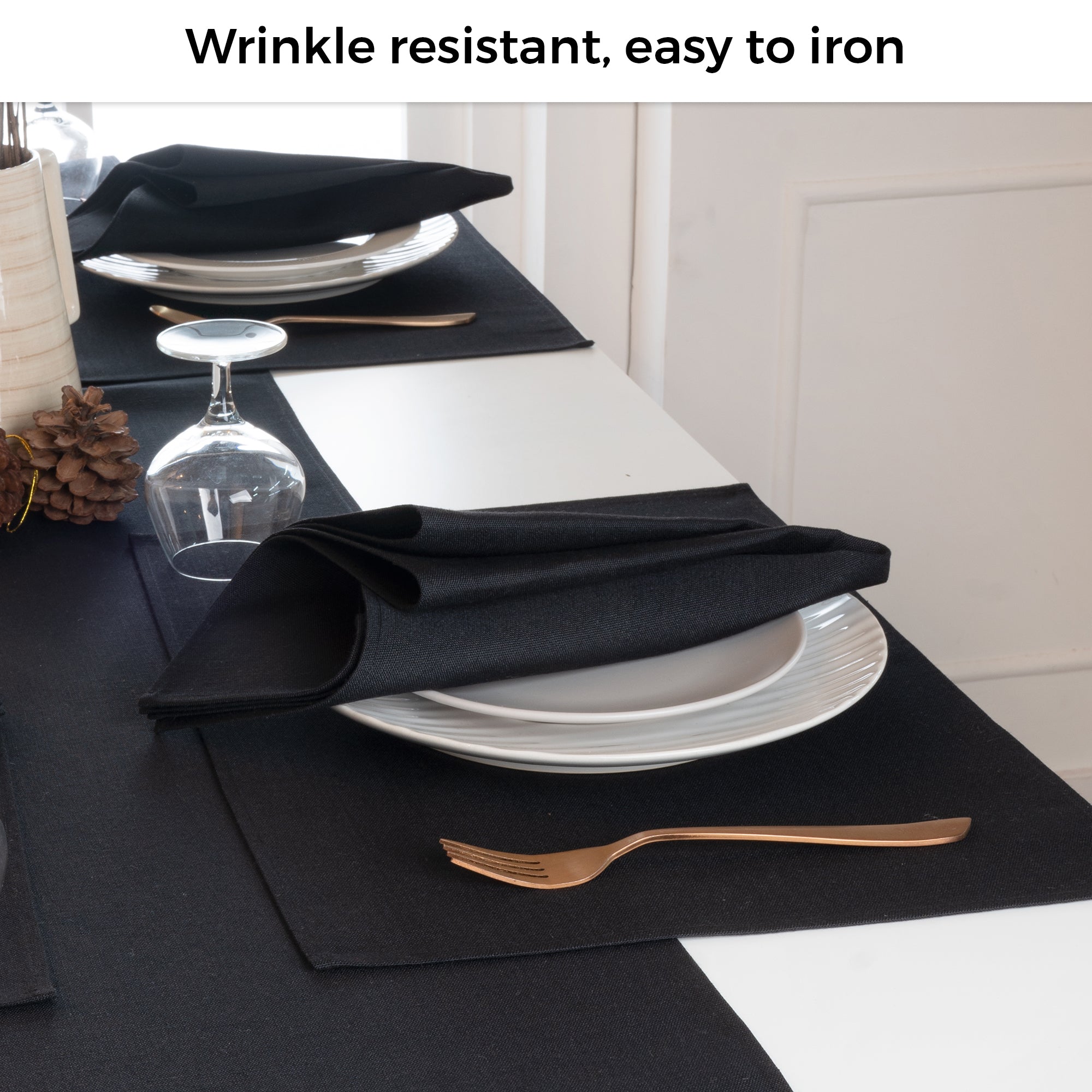Black faux linen placemats folded to show fabric texture
