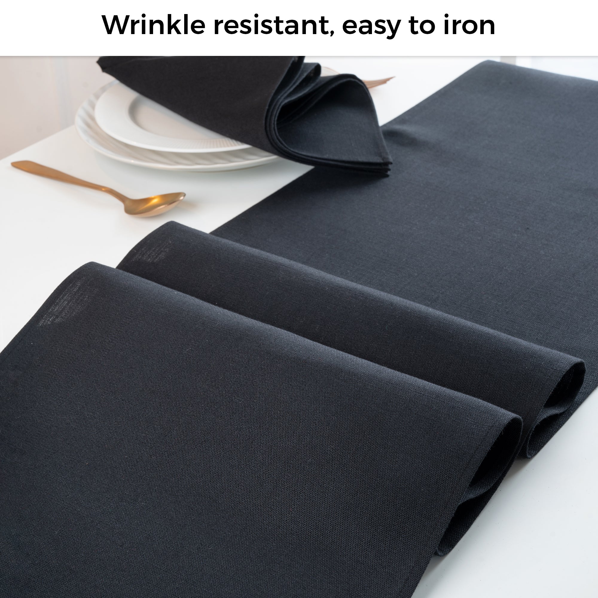 Black faux linen table runner folded to show fabric texture
